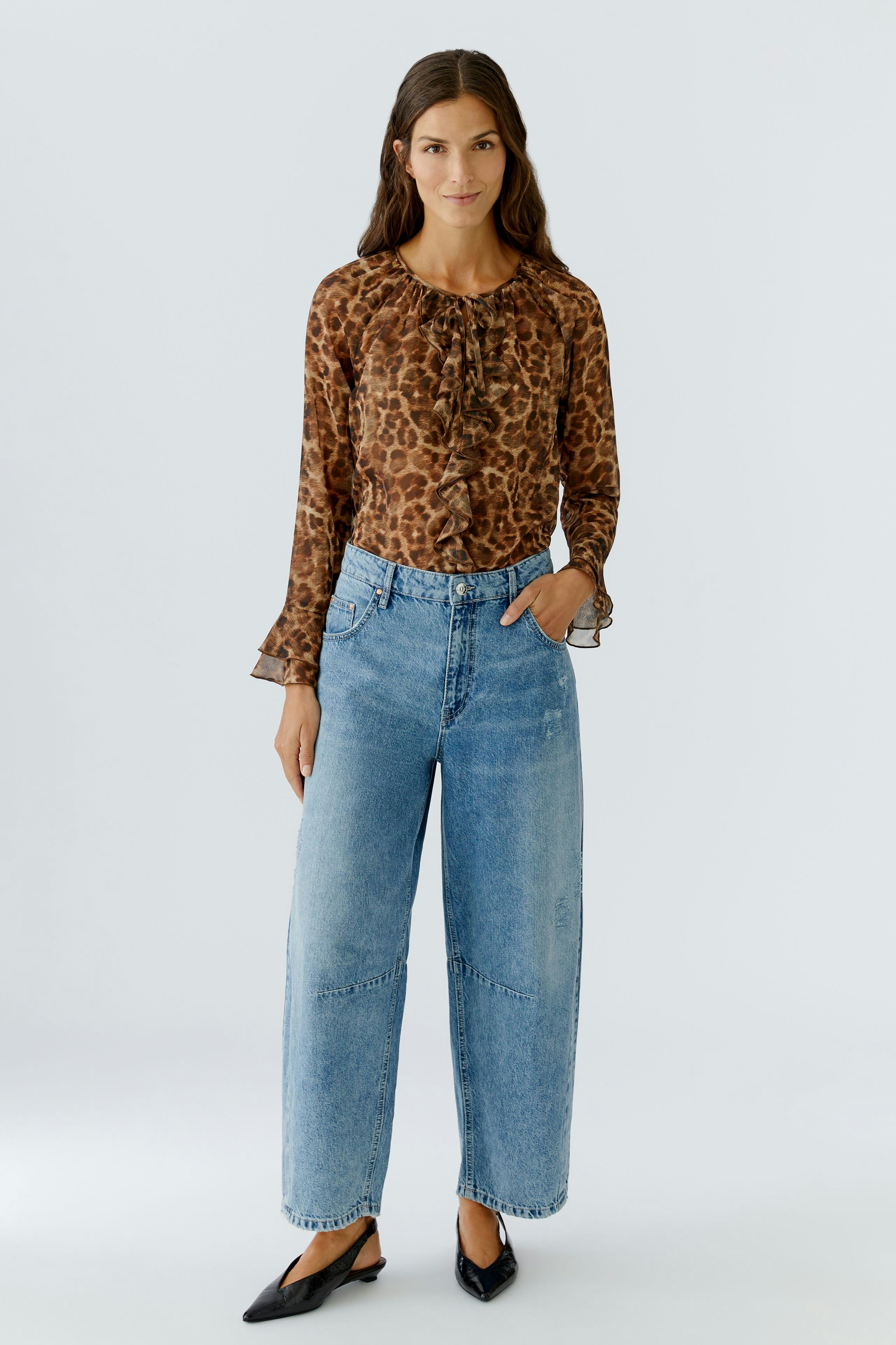 Leopard print blouse: Woman in a brown blouse with a round neckline and flared sleeves.