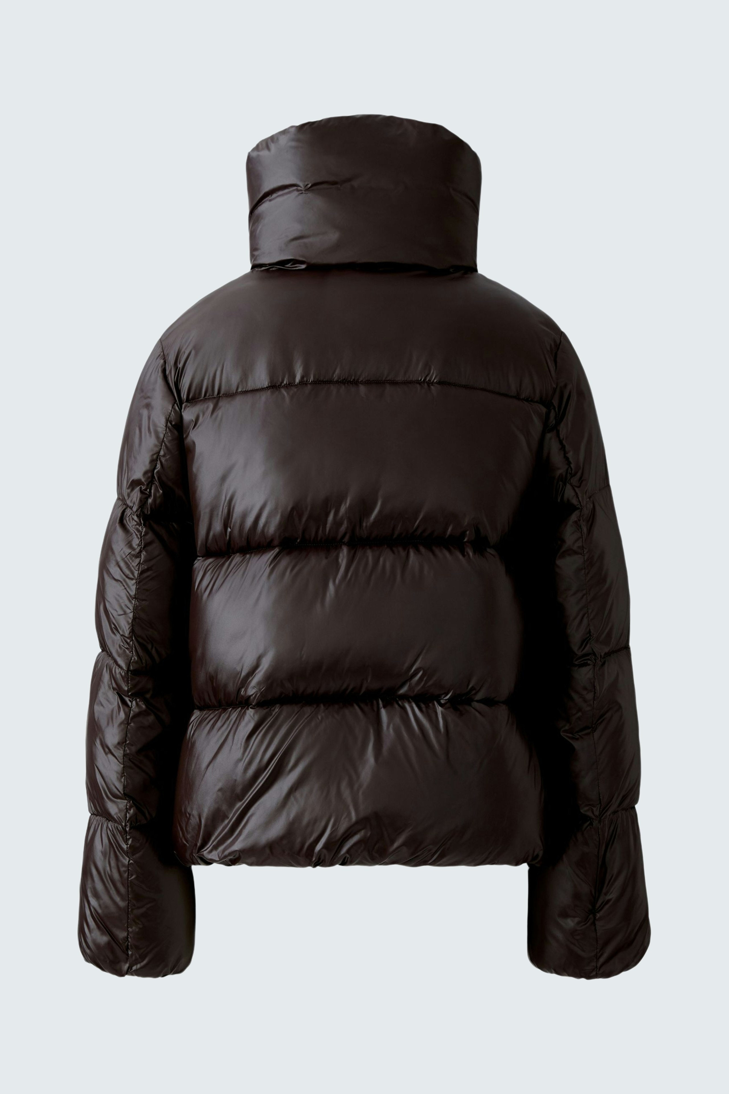 Stylish outdoor jacket: A woman in a dark brown puffer jacket with a high collar, perfect for chilly days.