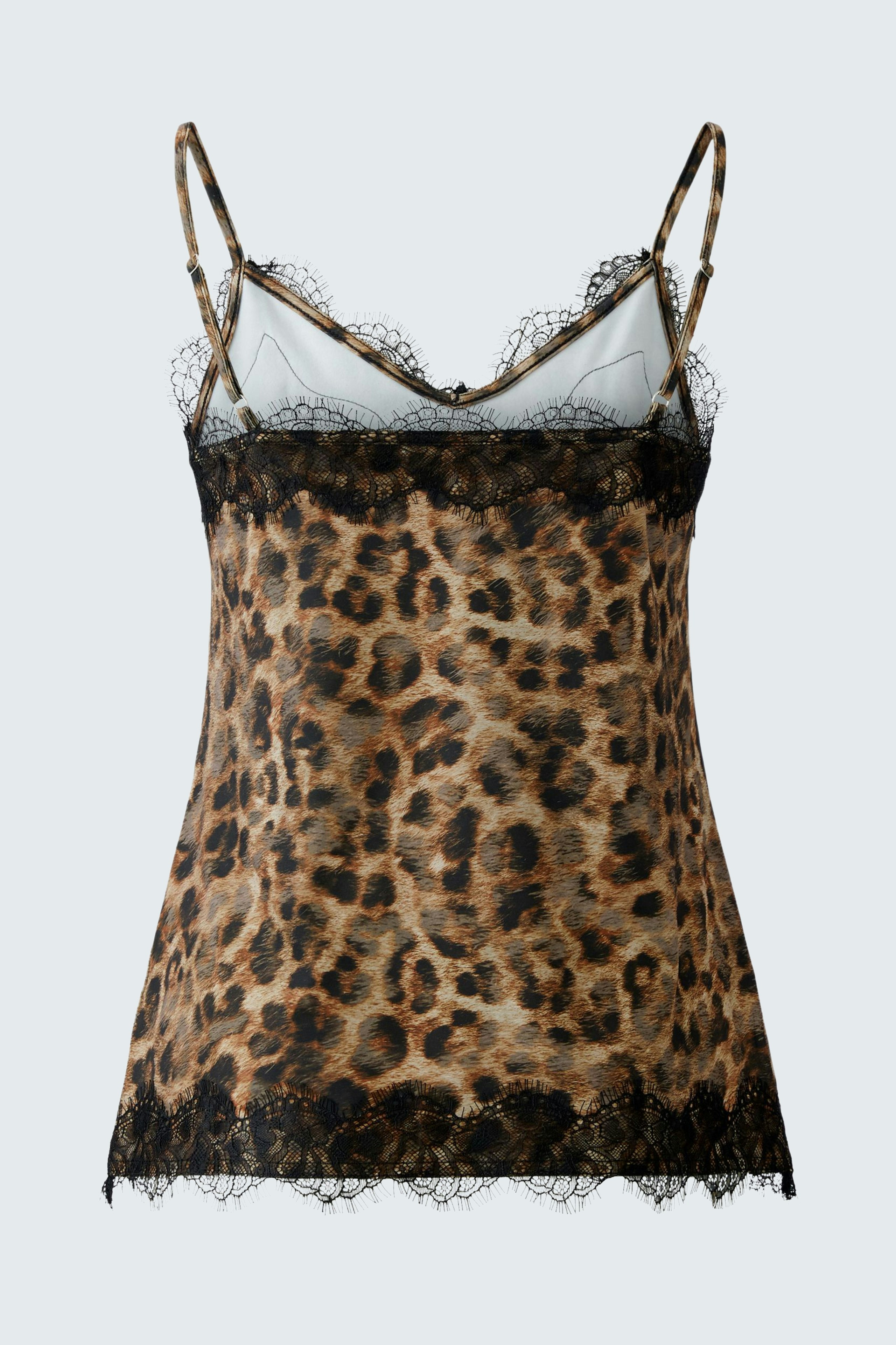 Leopard print top: A woman in a stylish leopard print top with lace trim and adjustable straps.