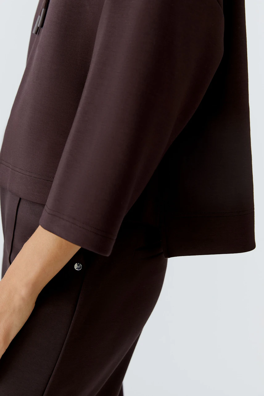 Casual women's hoodie in dark brown with a relaxed fit and stylish design.