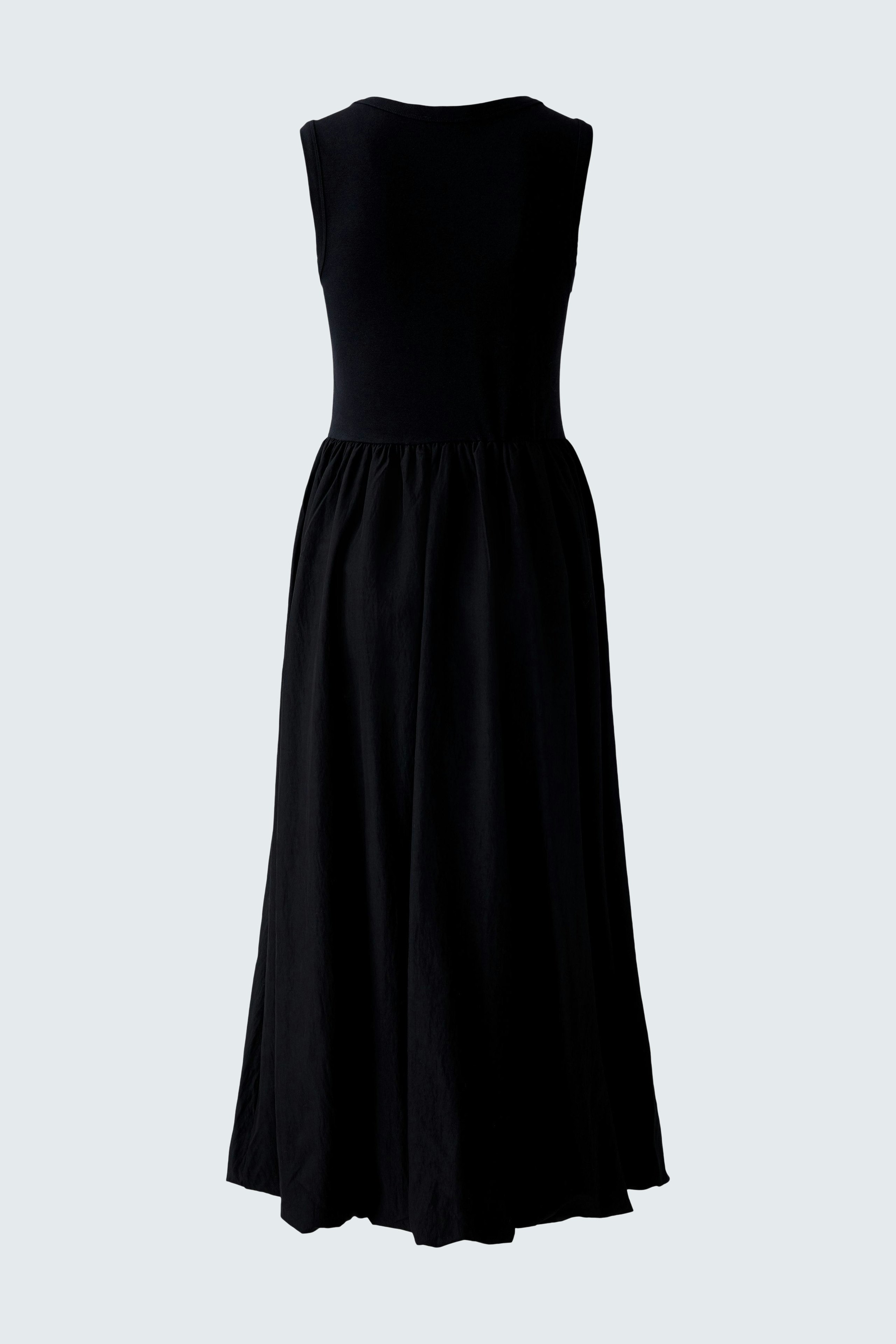 Casual black midi dress: A woman showcases a simple, sleeveless design with a flowing skirt.