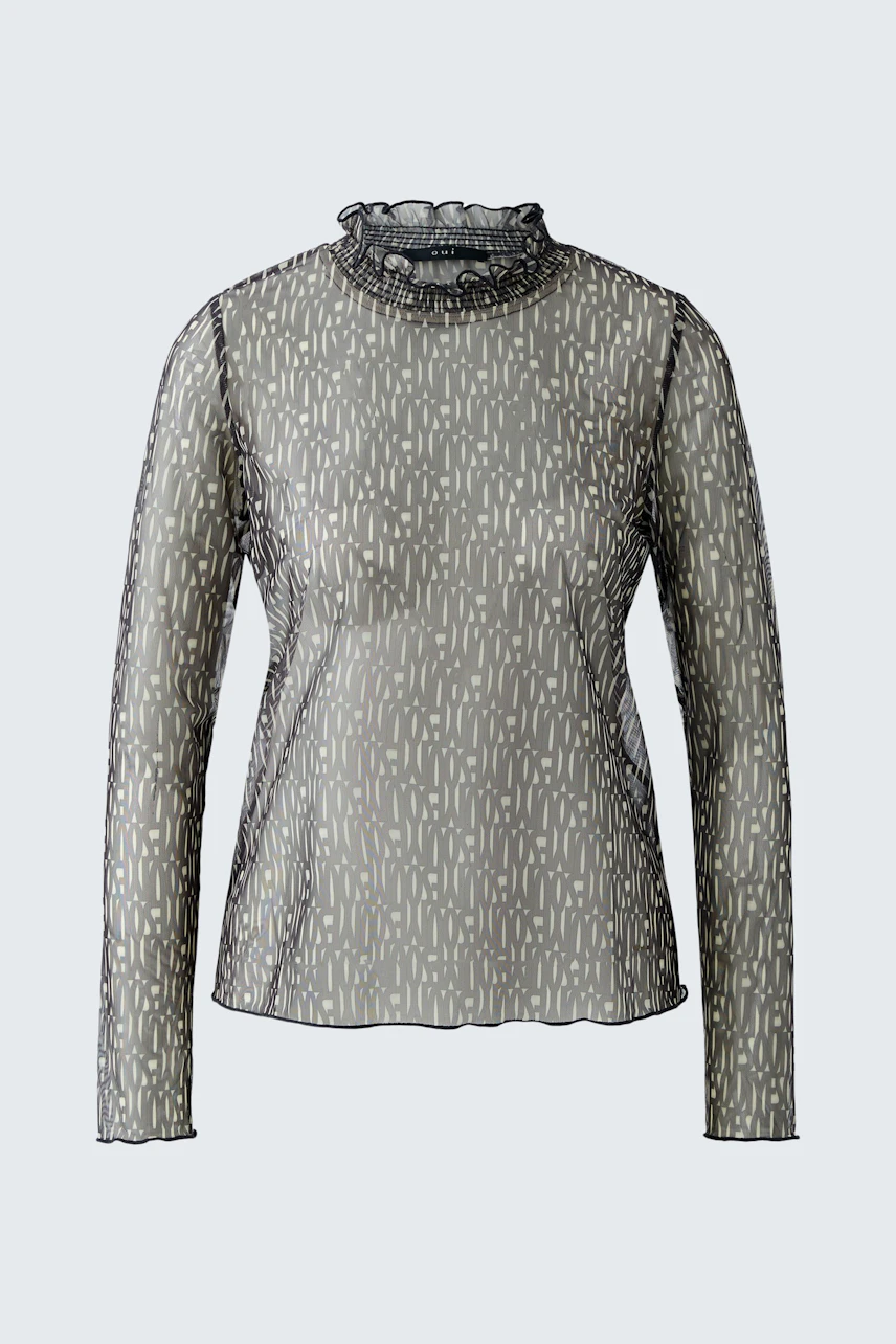 Stylish long-sleeve shirt: A woman in a patterned top with a high neckline, perfect for casual wear.