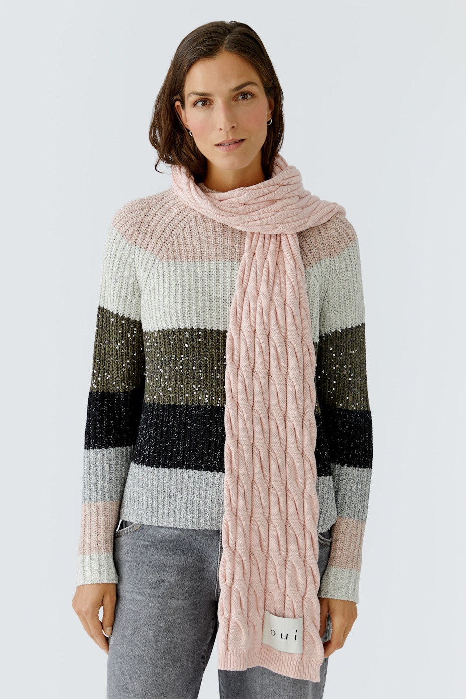Cozy women's scarf in soft pink with a textured pattern, perfect for layering.