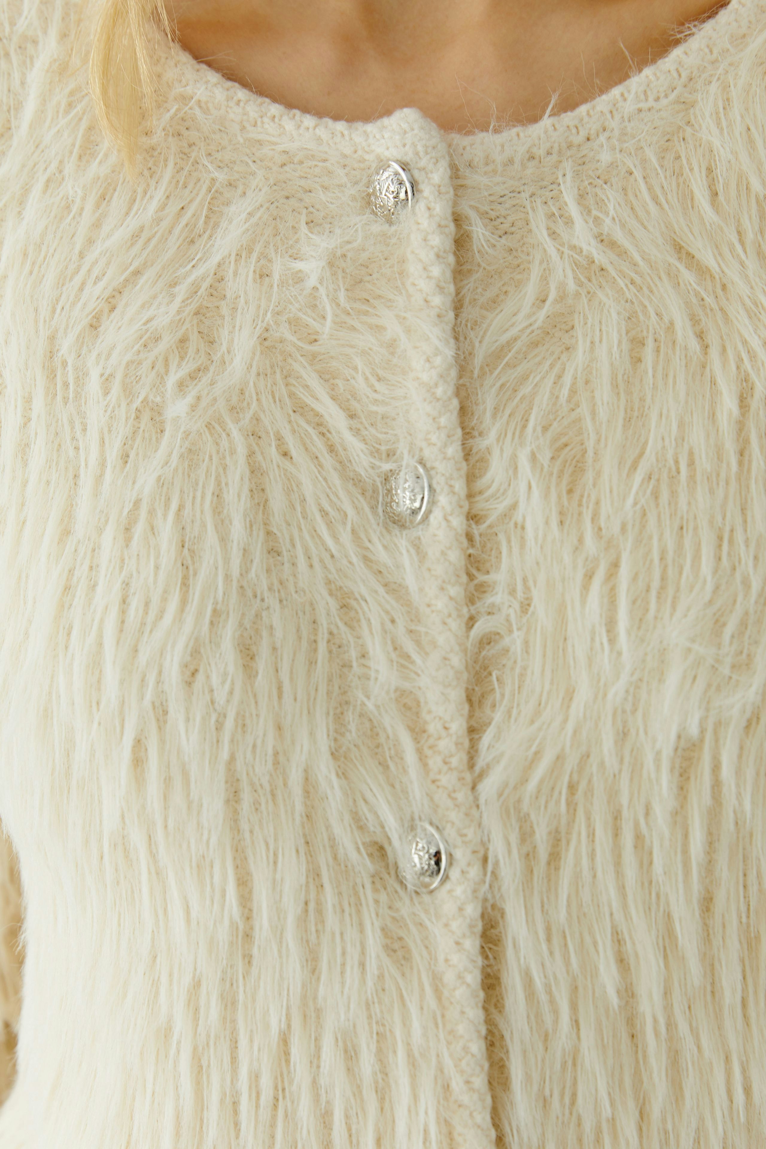 Cozy women's cardigan with a fluffy texture and button closure, perfect for layering.