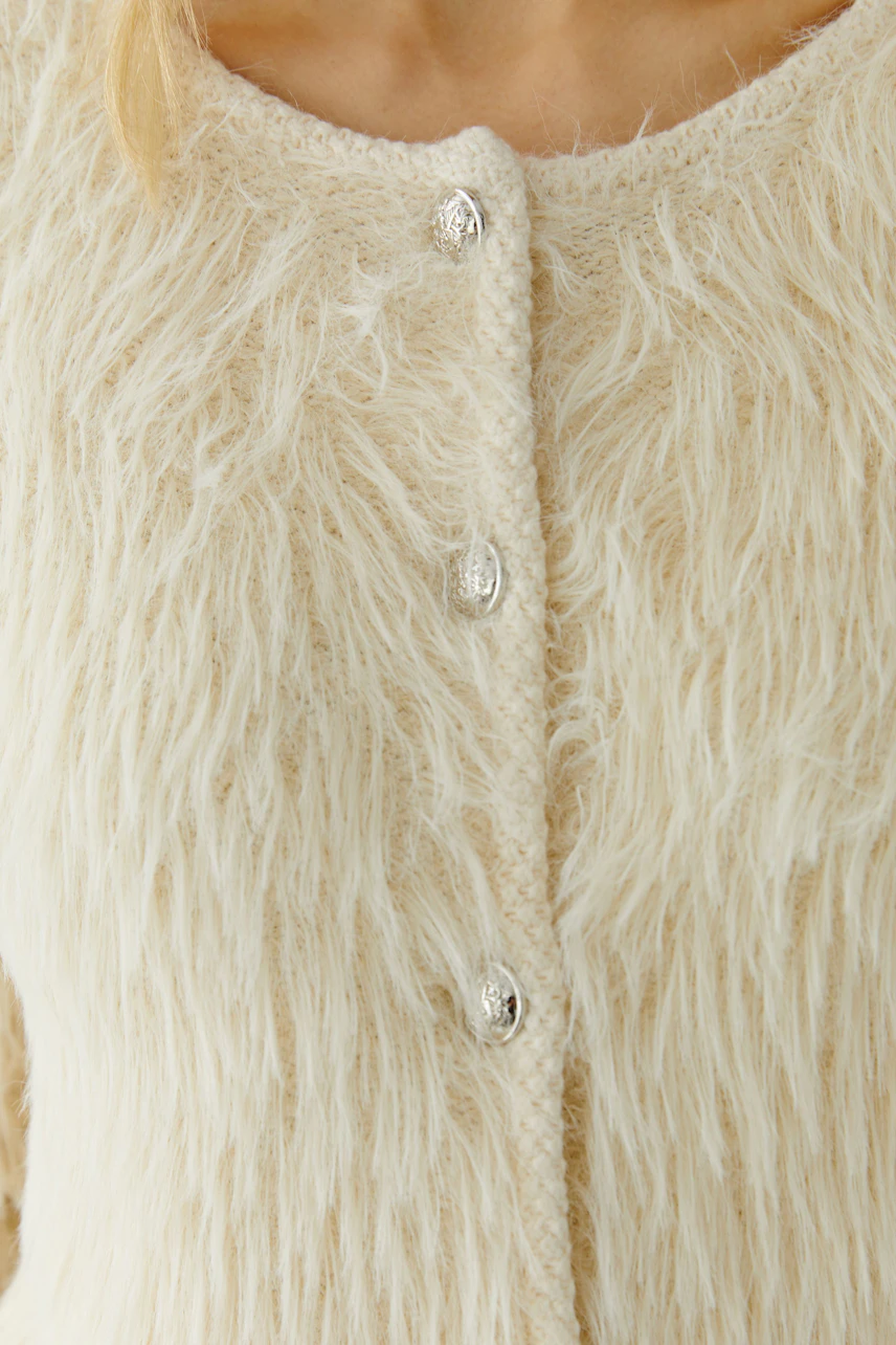 Cozy women's cardigan with a fluffy texture and button closure, perfect for layering.