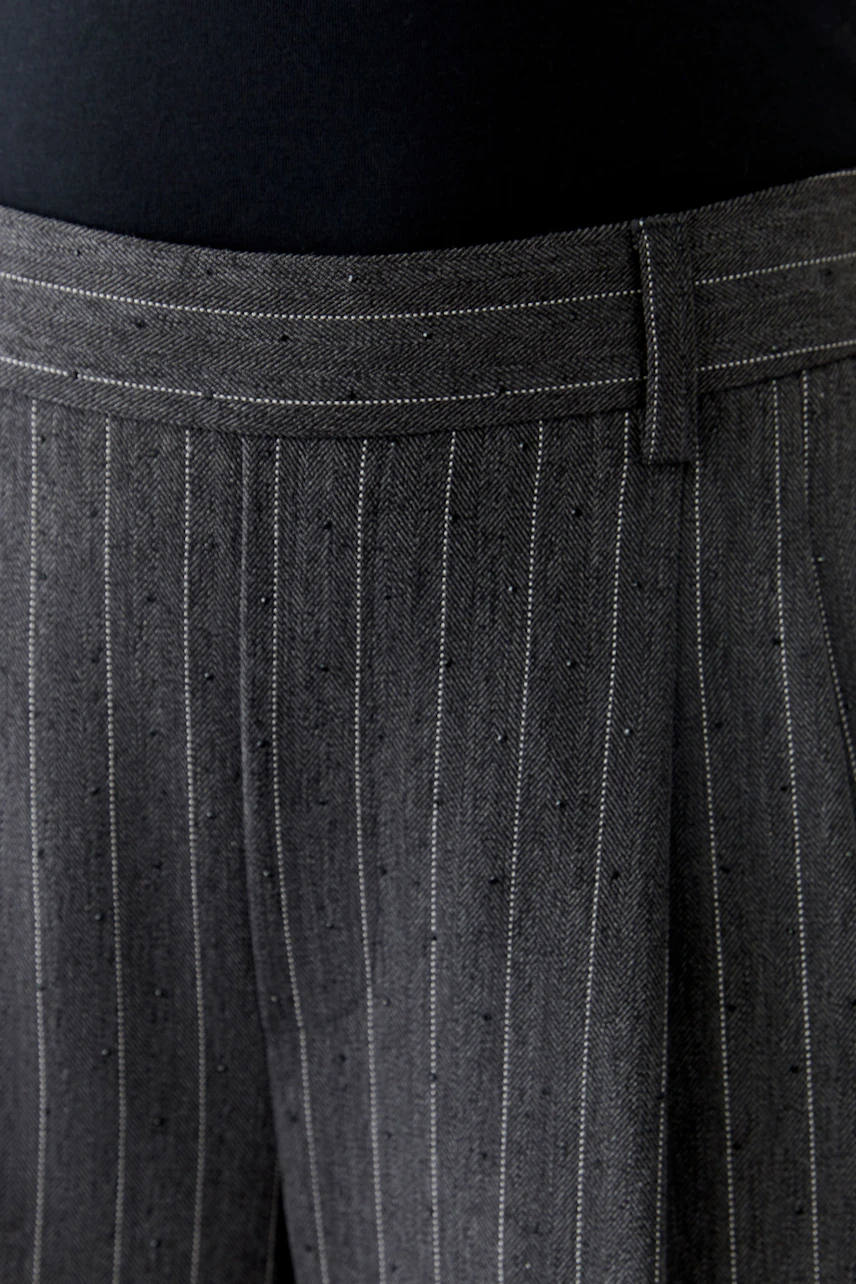 Stylish women's pleated trousers with a modern pinstripe design, perfect for casual wear.