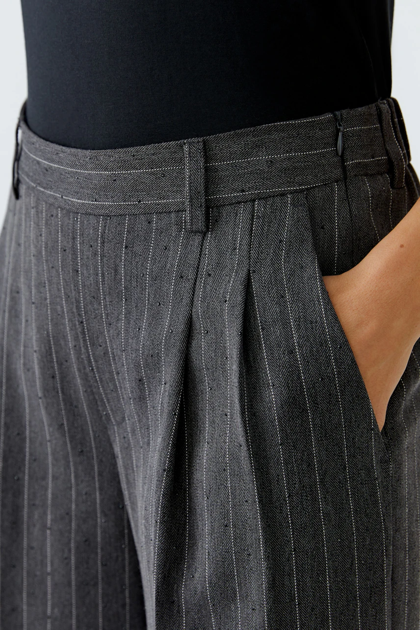 Stylish women's pleated trousers in gray pinstripe with pockets, perfect for casual wear.