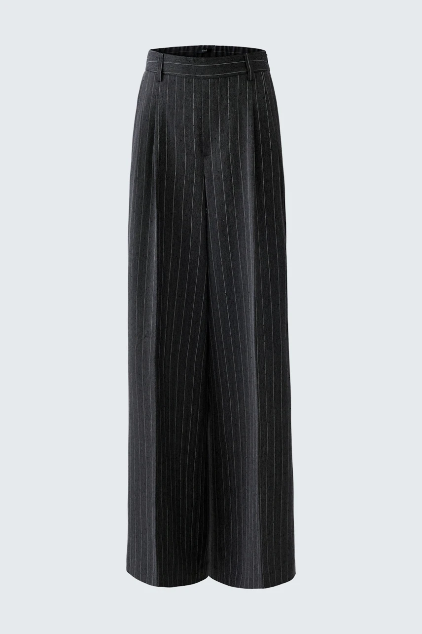 Wide-leg trousers: A woman in stylish, pinstriped trousers, perfect for casual or office wear.