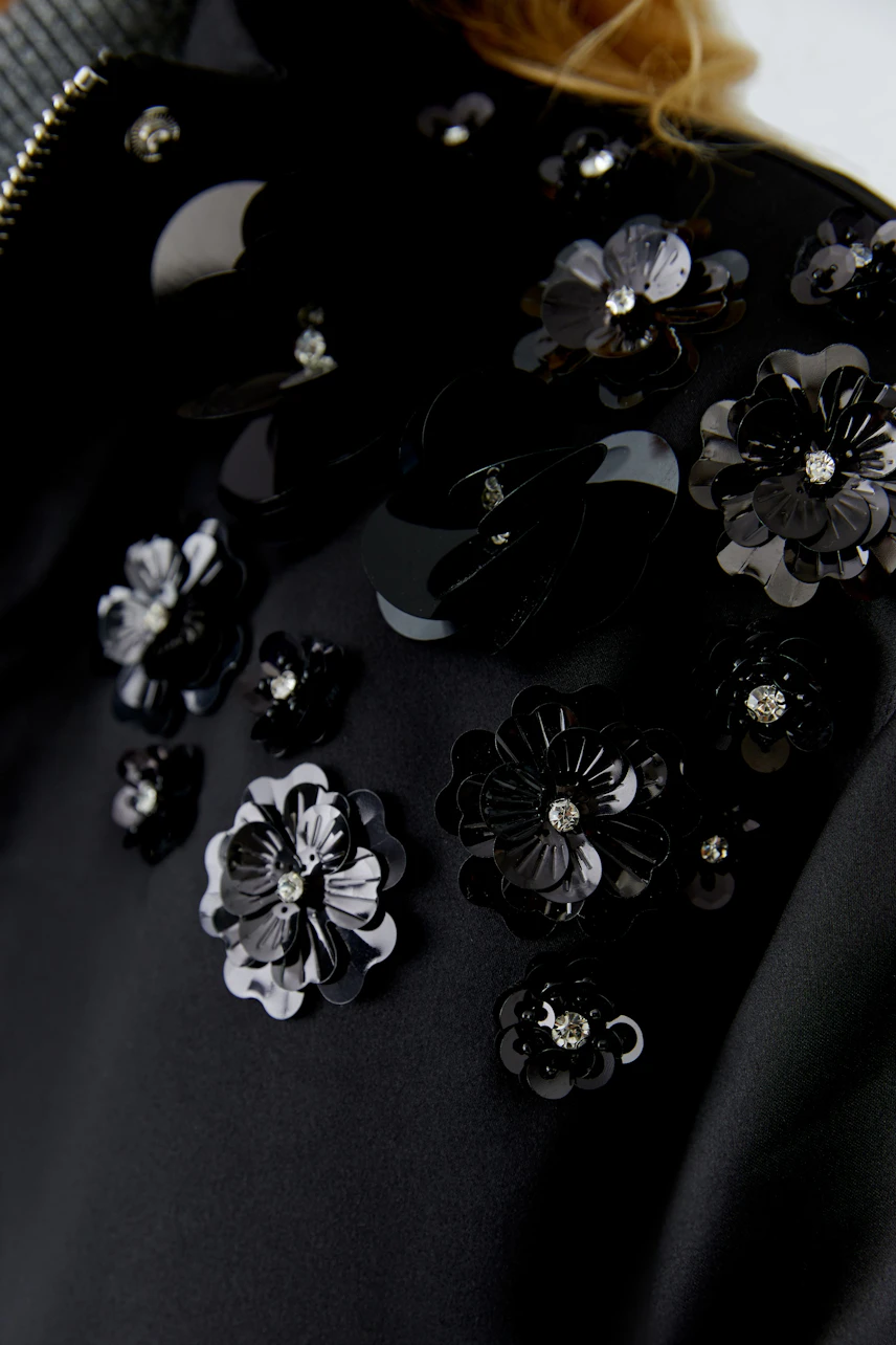 Stylish women's blouson with floral embellishments, perfect for casual outings.