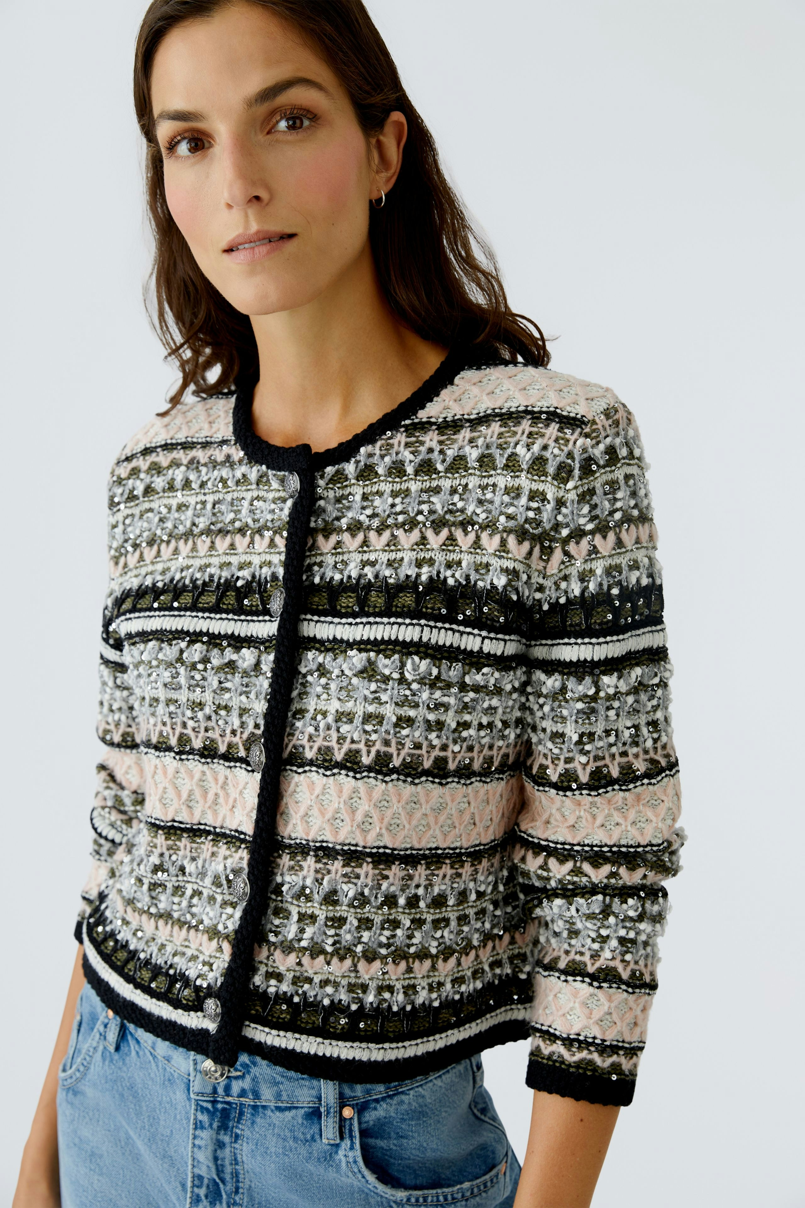 Casual women's cardigan: A woman in a patterned cardigan with a round neckline and three-quarter sleeves.