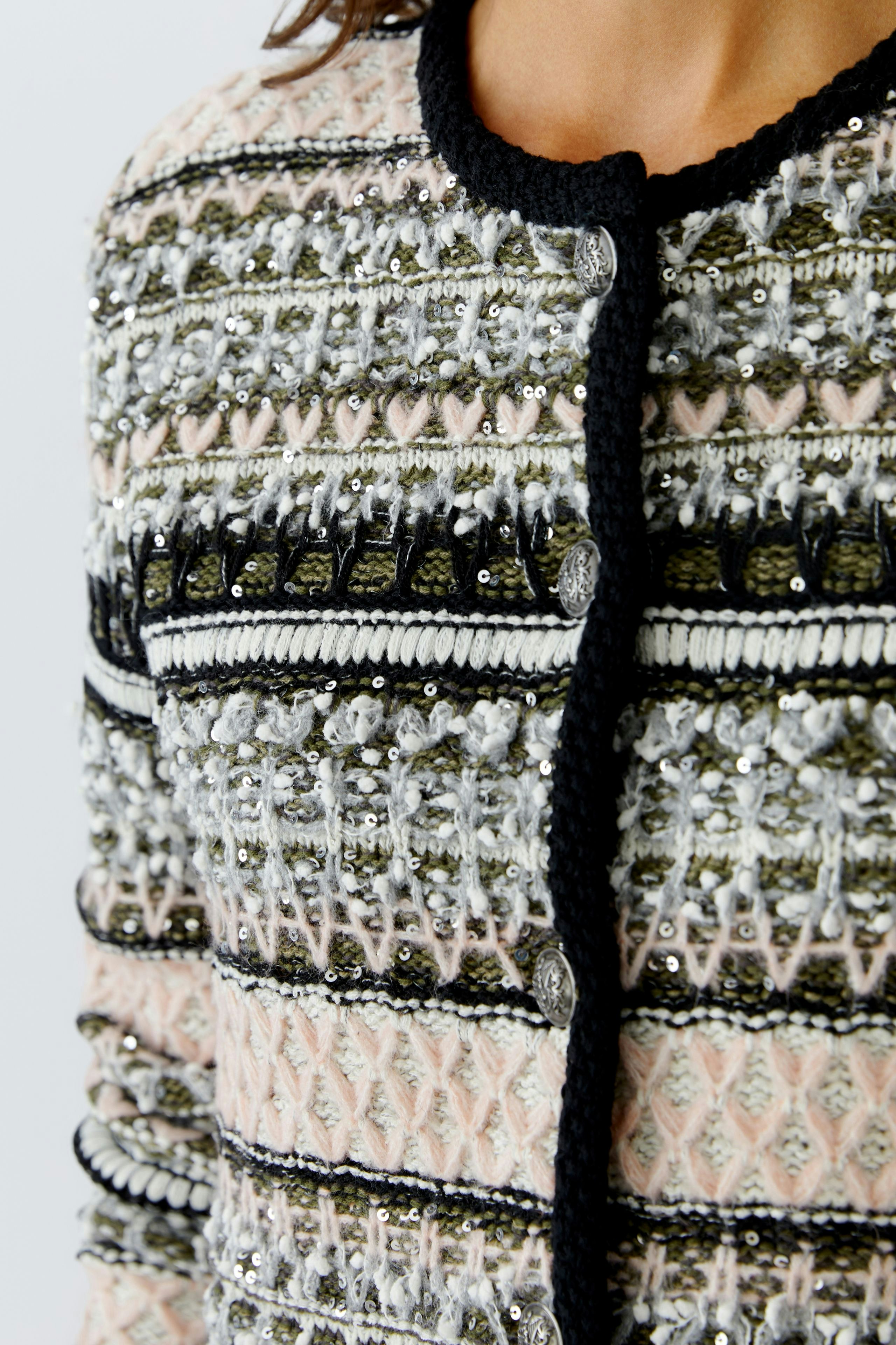 Stylish women's cardigan: Close-up of a woman in a colorful knitted cardigan with decorative details.