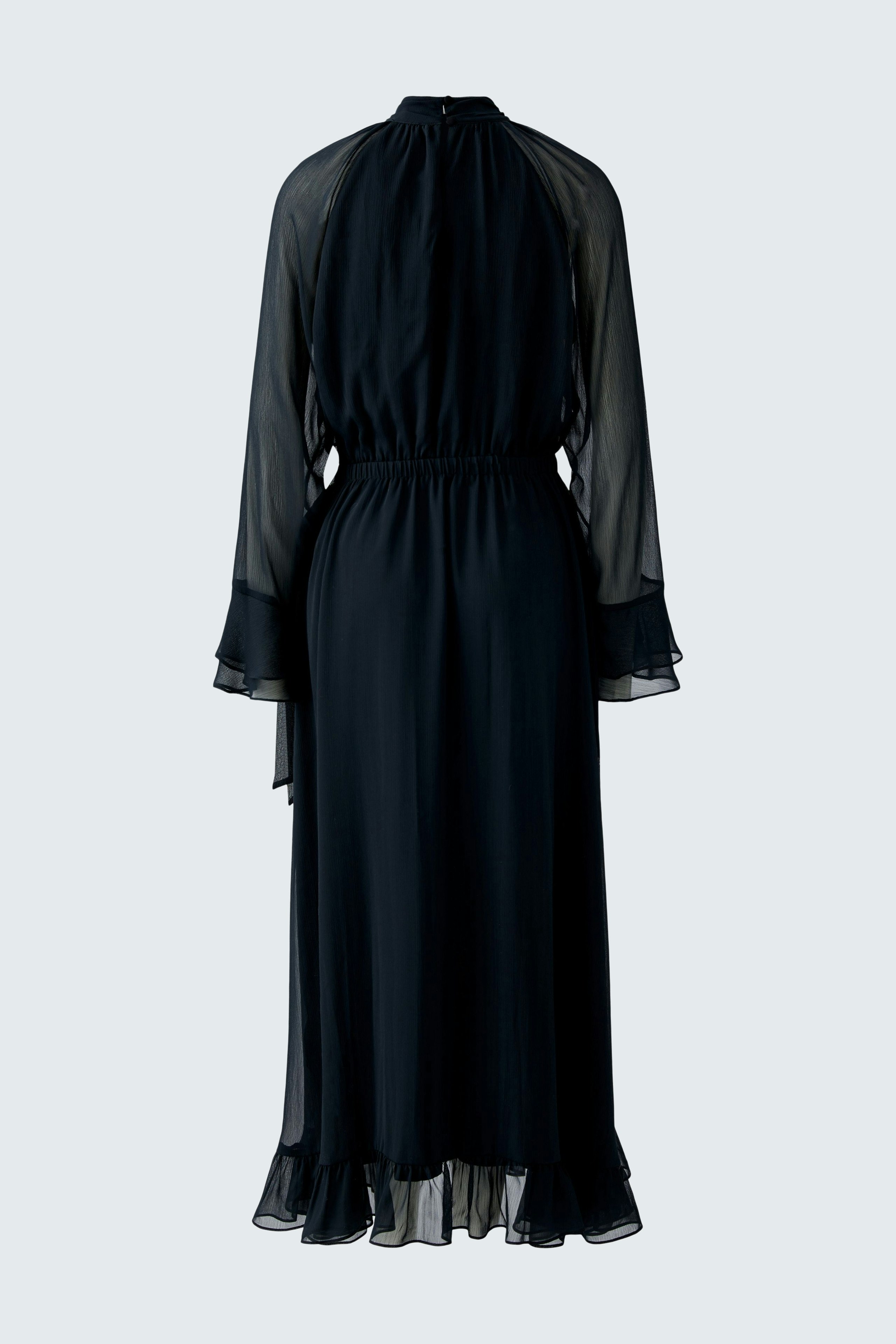 Flowy maxi dress: A woman in a black, lightweight maxi dress with a cinched waist and sheer sleeves.