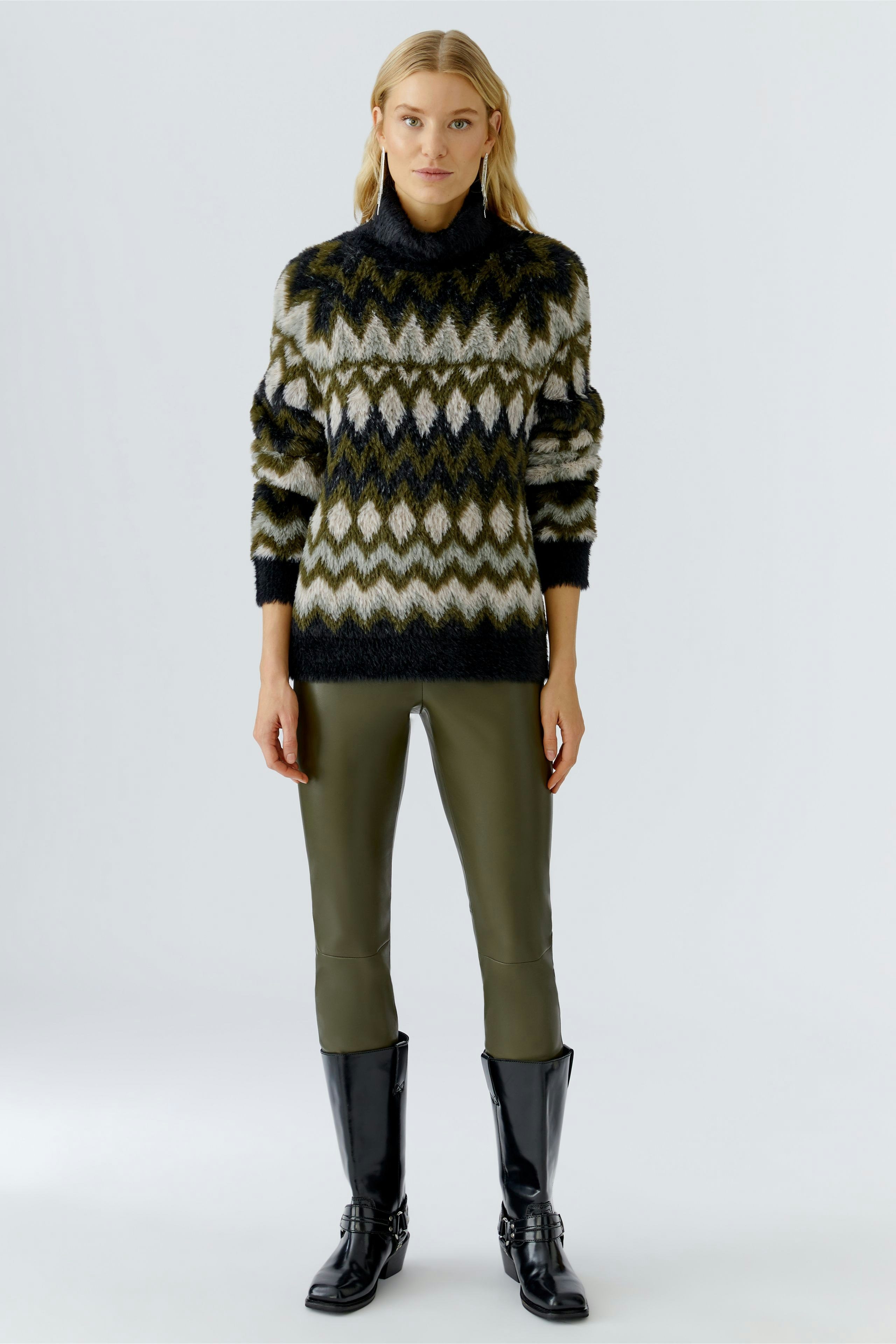 Stylish women's pullover: A woman in a patterned pullover with a high collar and relaxed fit.
