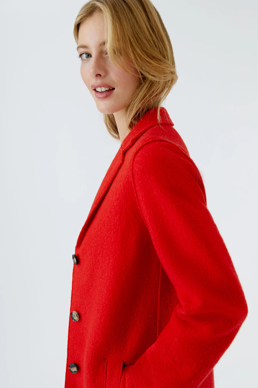 Stylish women's wool coat in vibrant red, featuring a classic design and button details.