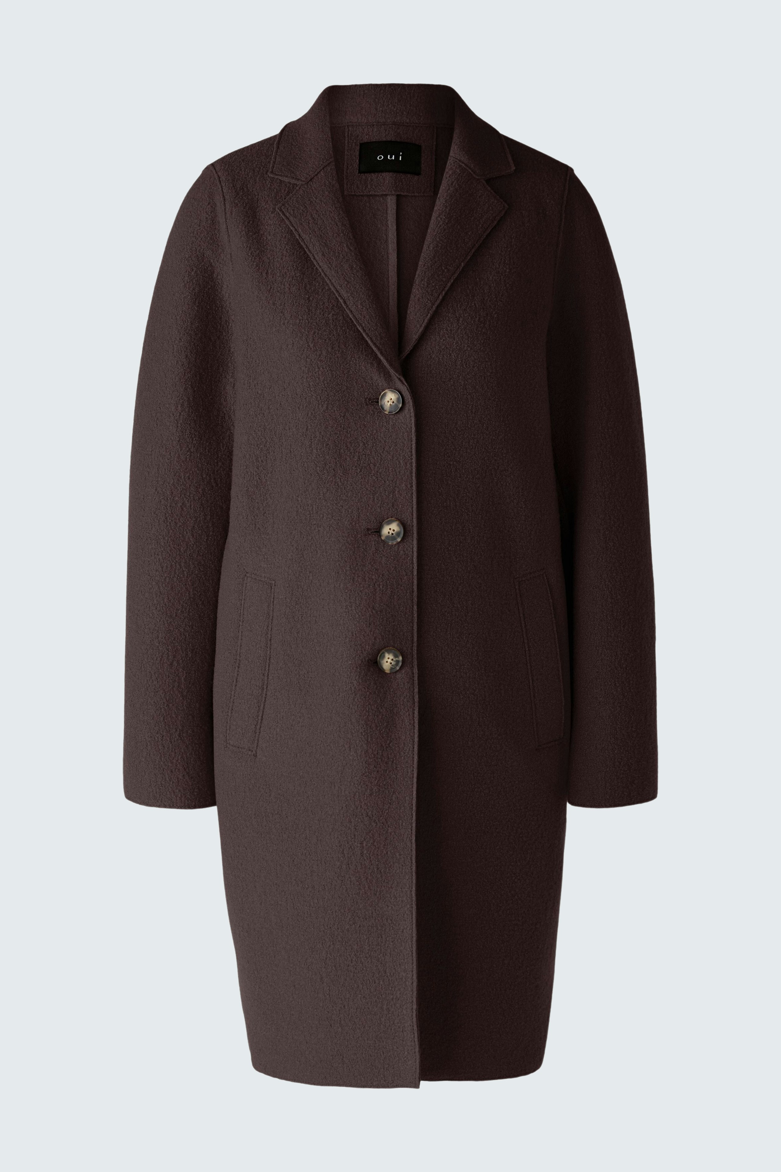 Modern women's wool coat: A woman in a brown wool coat with buttons and side pockets.