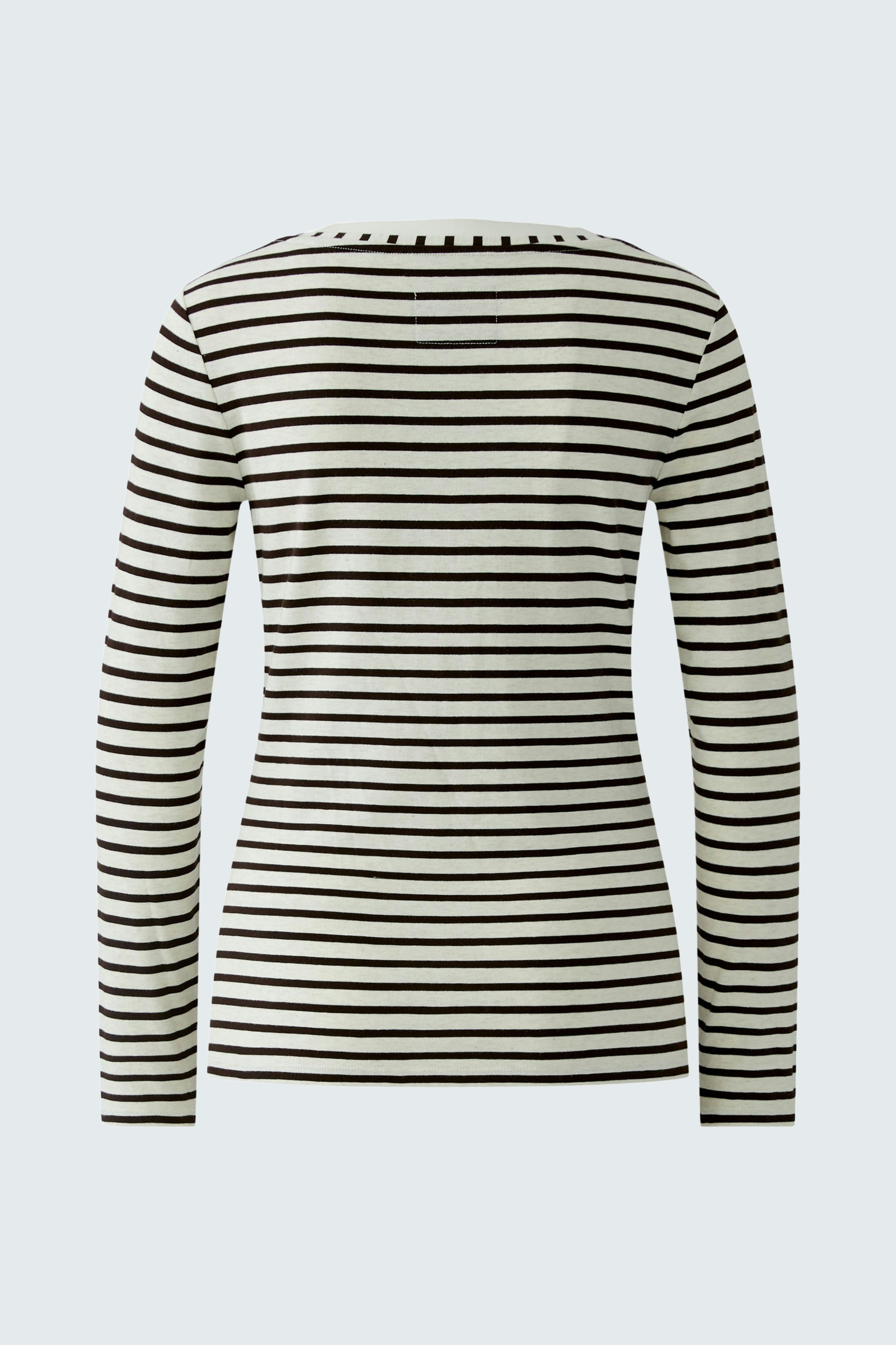 Casual long-sleeve shirt: A woman in a striped pullover, showcasing a relaxed fit and comfortable style.