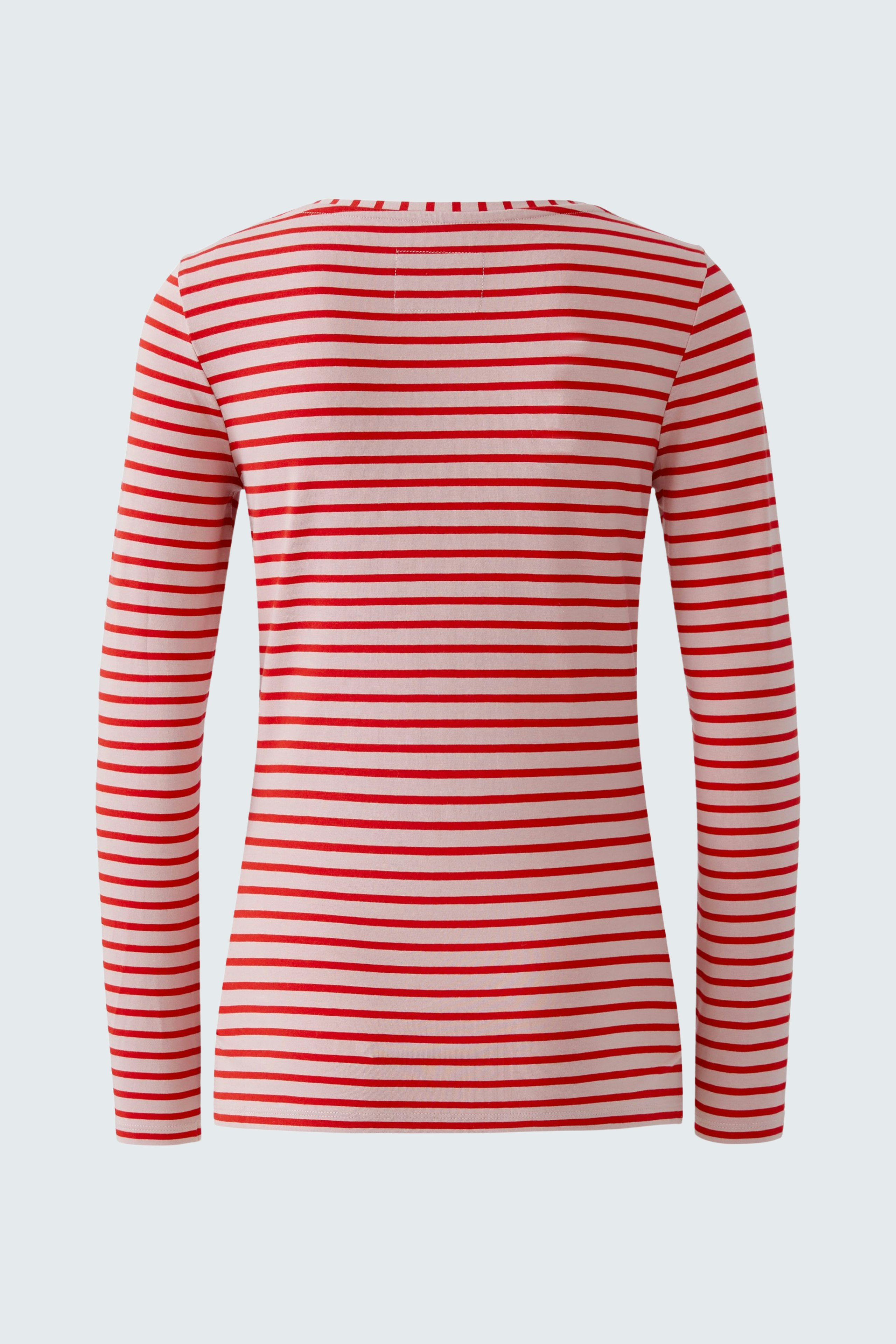 Casual long-sleeve shirt: A woman in a red and white striped pullover, showcasing a relaxed fit.