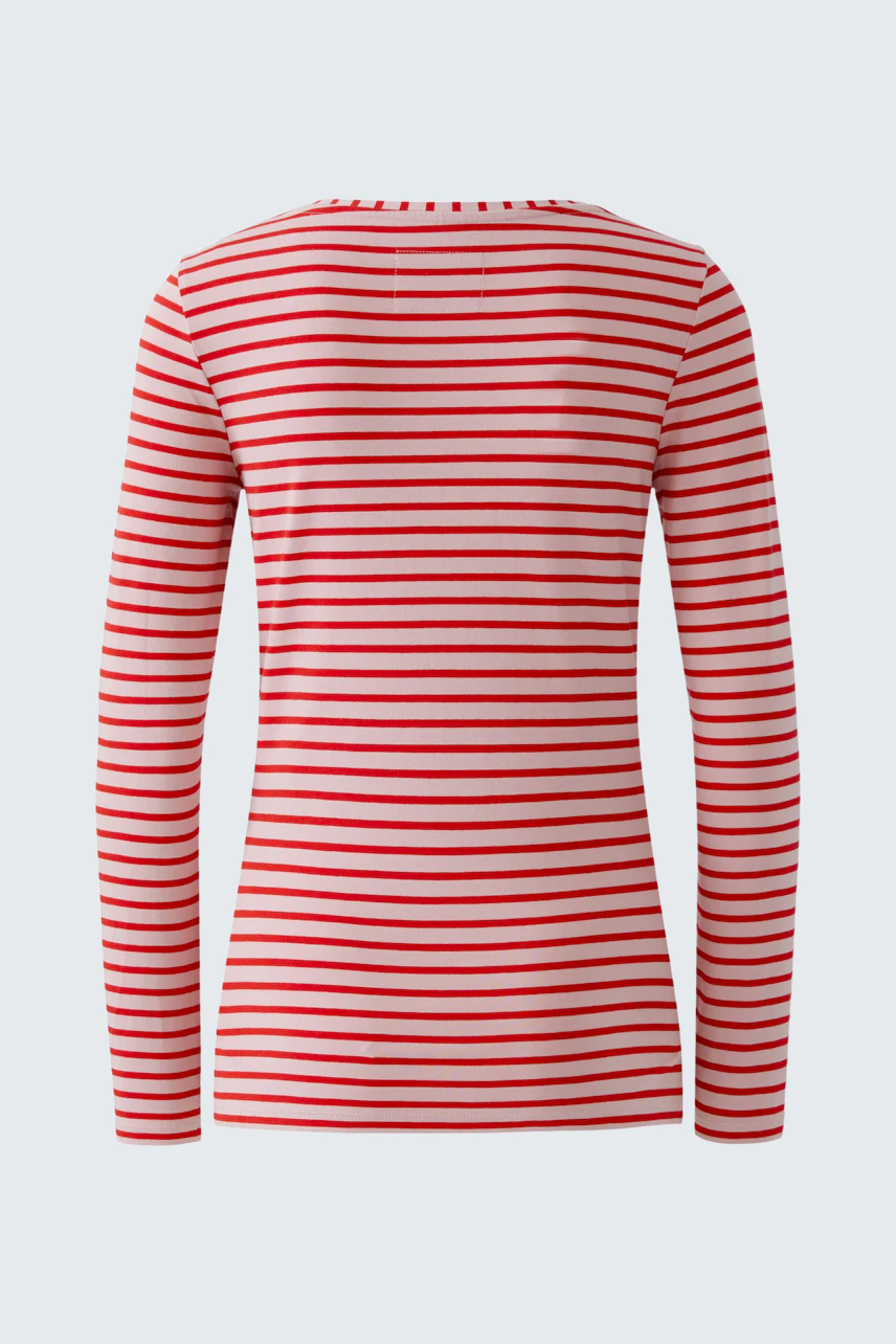 Casual long-sleeve shirt: A woman in a red and white striped pullover, showcasing a relaxed fit.