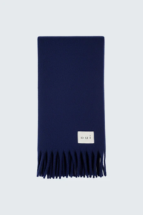 Soft women's scarf in deep blue with fringes, perfect for layering in cooler weather.