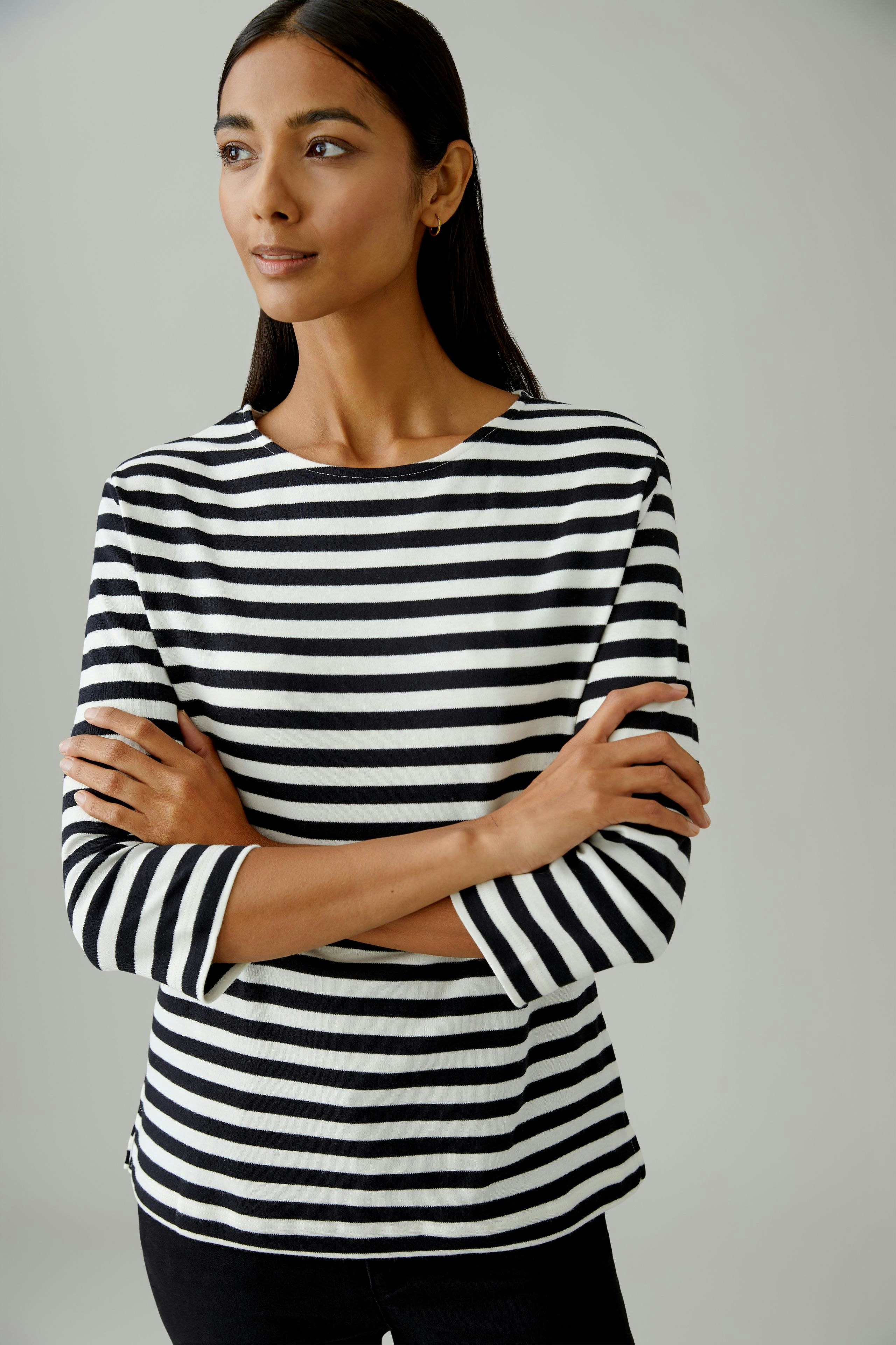 Casual women's T-shirt: A woman in a black and white striped top with three-quarter sleeves.