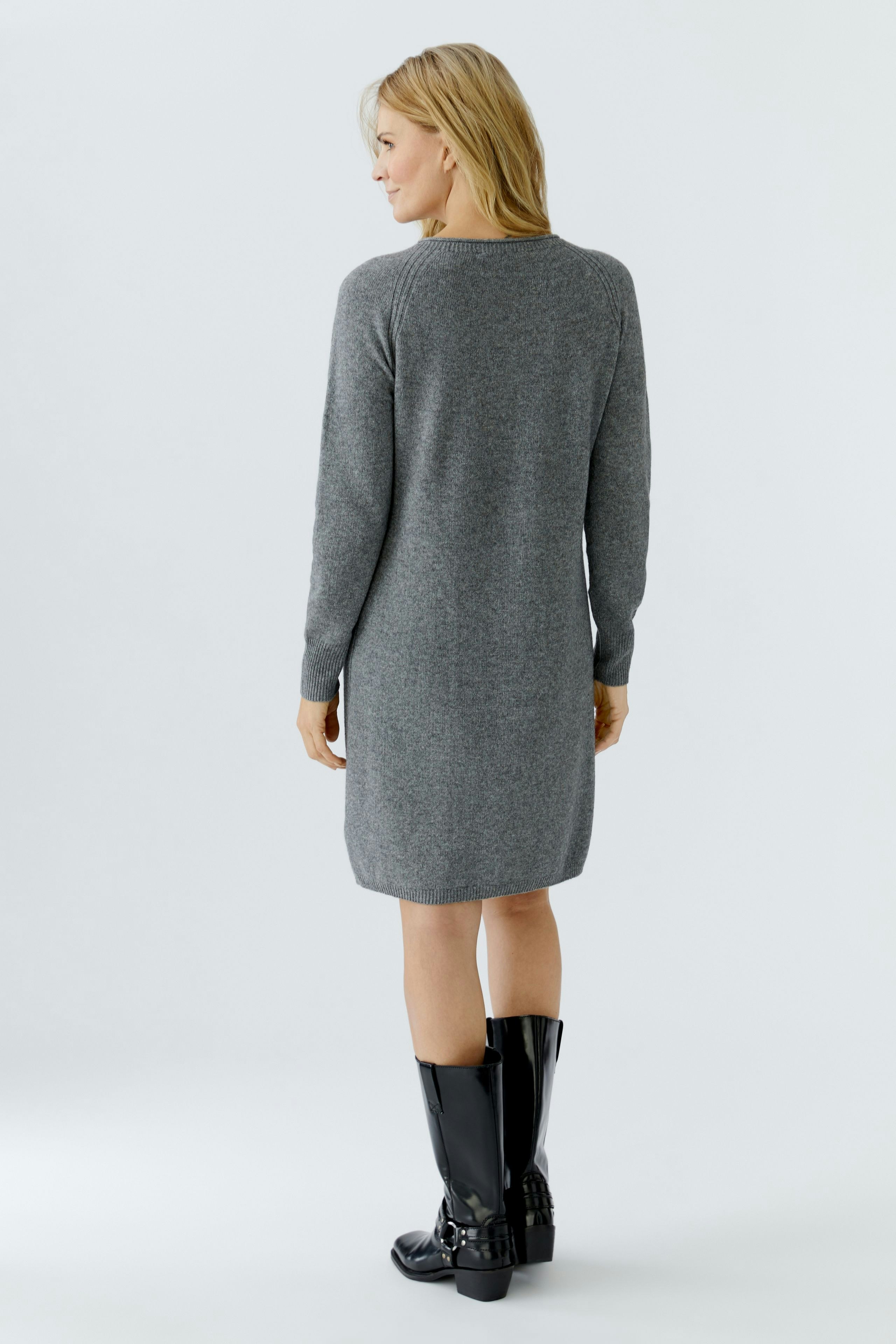 Casual women's knit dress: A woman in a gray knit dress, showcasing a relaxed fit and long sleeves.