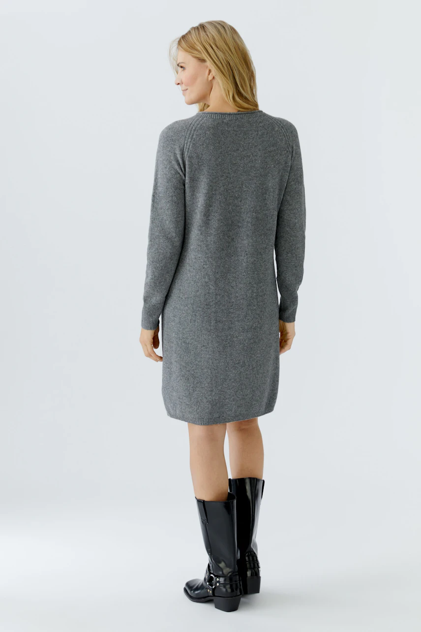 Casual women's knit dress: A woman in a gray knit dress, showcasing a relaxed fit and long sleeves.