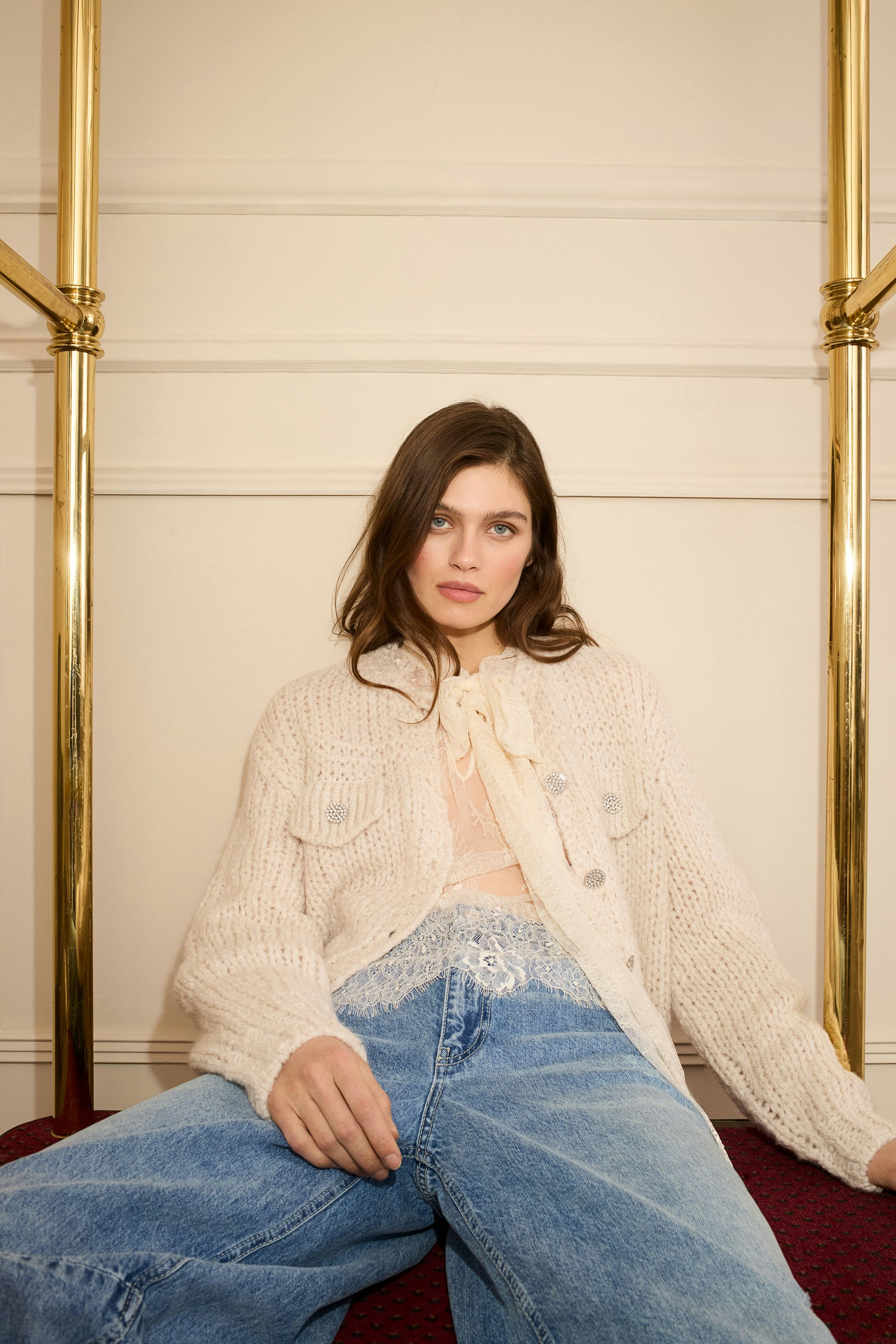 Casual women's blouse: Young woman in a light knit blouse with a relaxed fit, paired with denim.