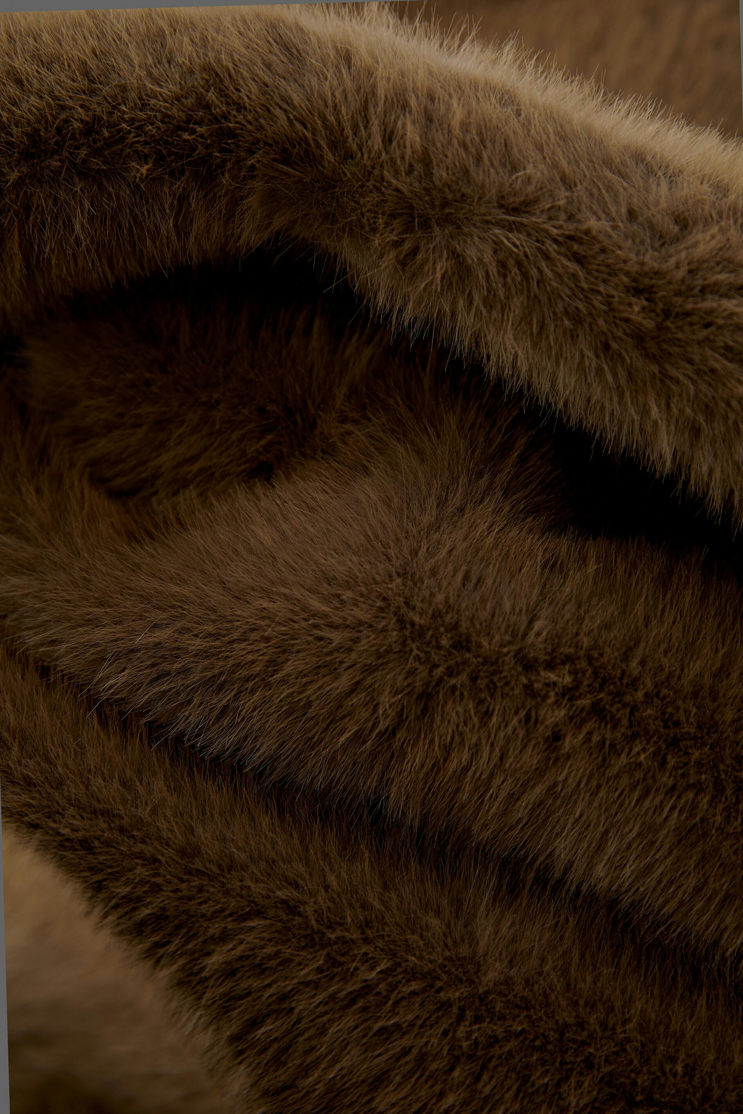 Soft brown scarf with a plush texture, perfect for cozy layering.