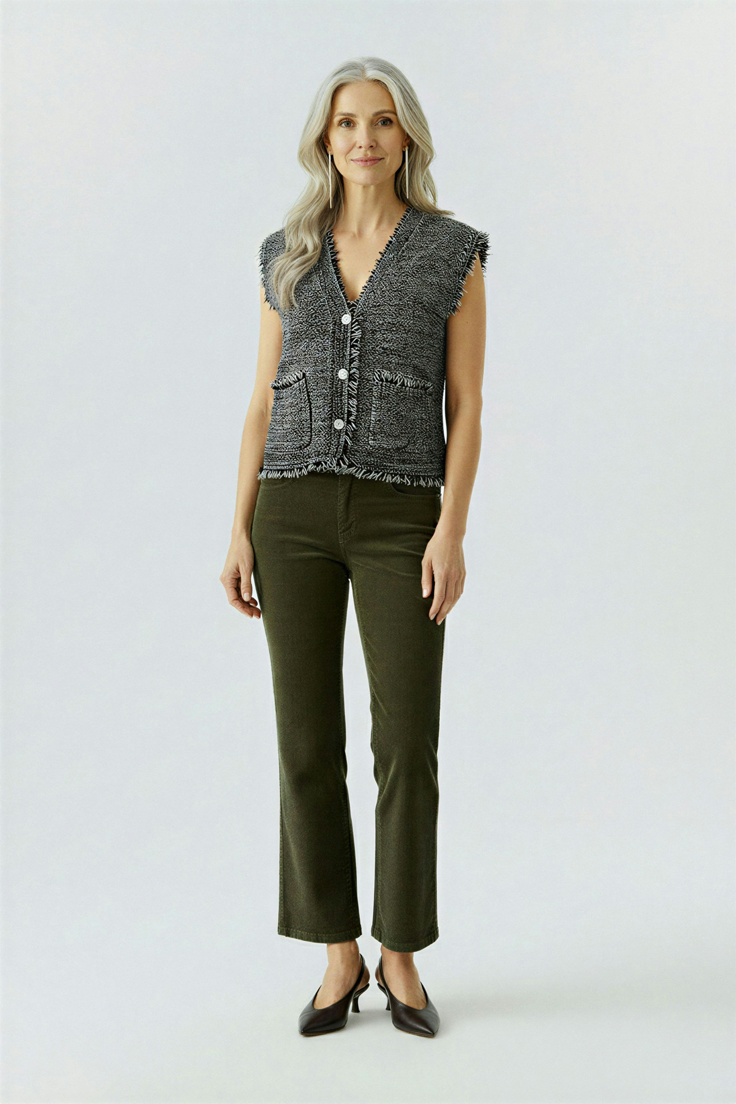 Casual women's cardigan: A woman in a gray knitted vest with pockets and a relaxed fit.