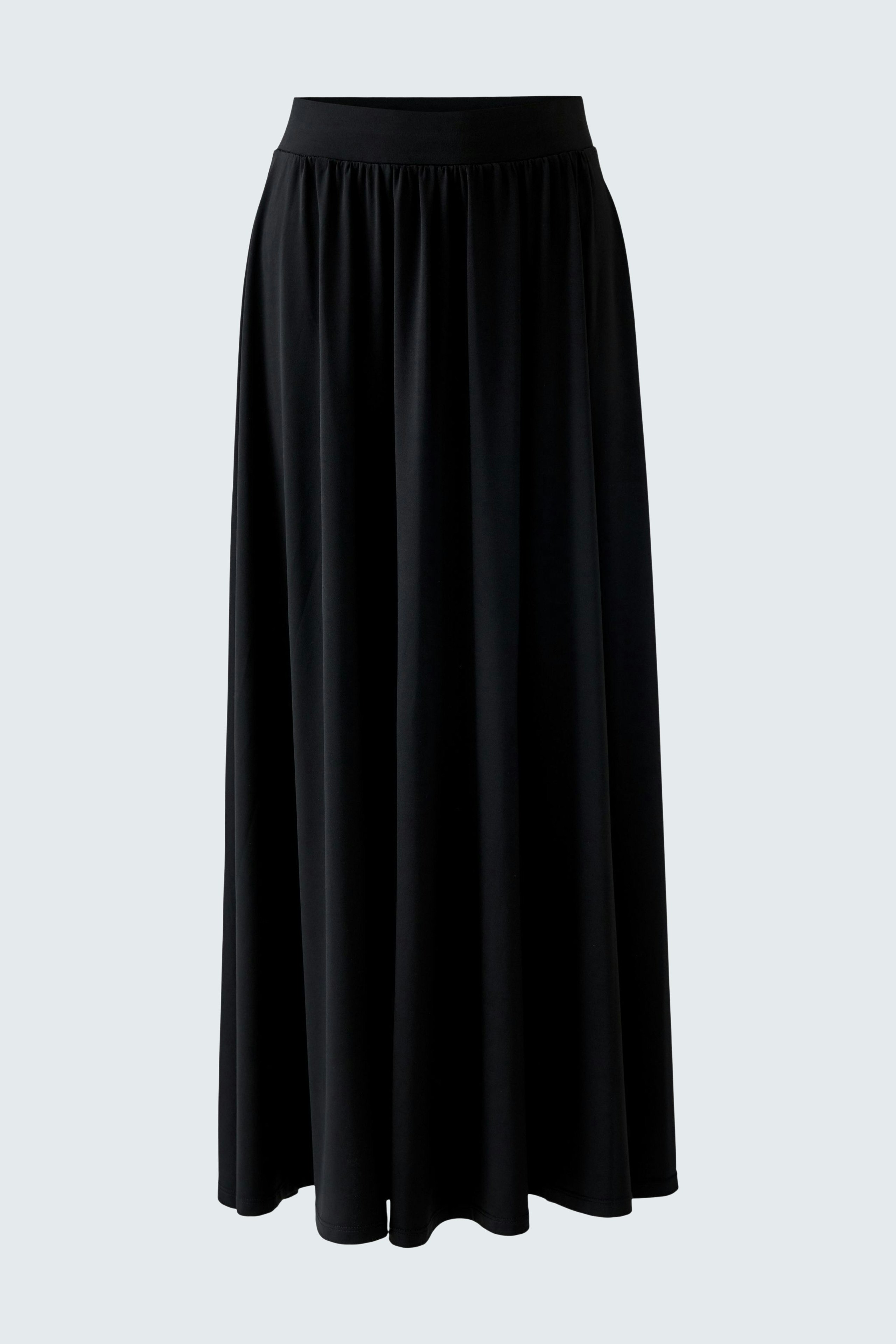 Flowy A-line skirt: A woman in a black A-line skirt, perfect for casual outings.