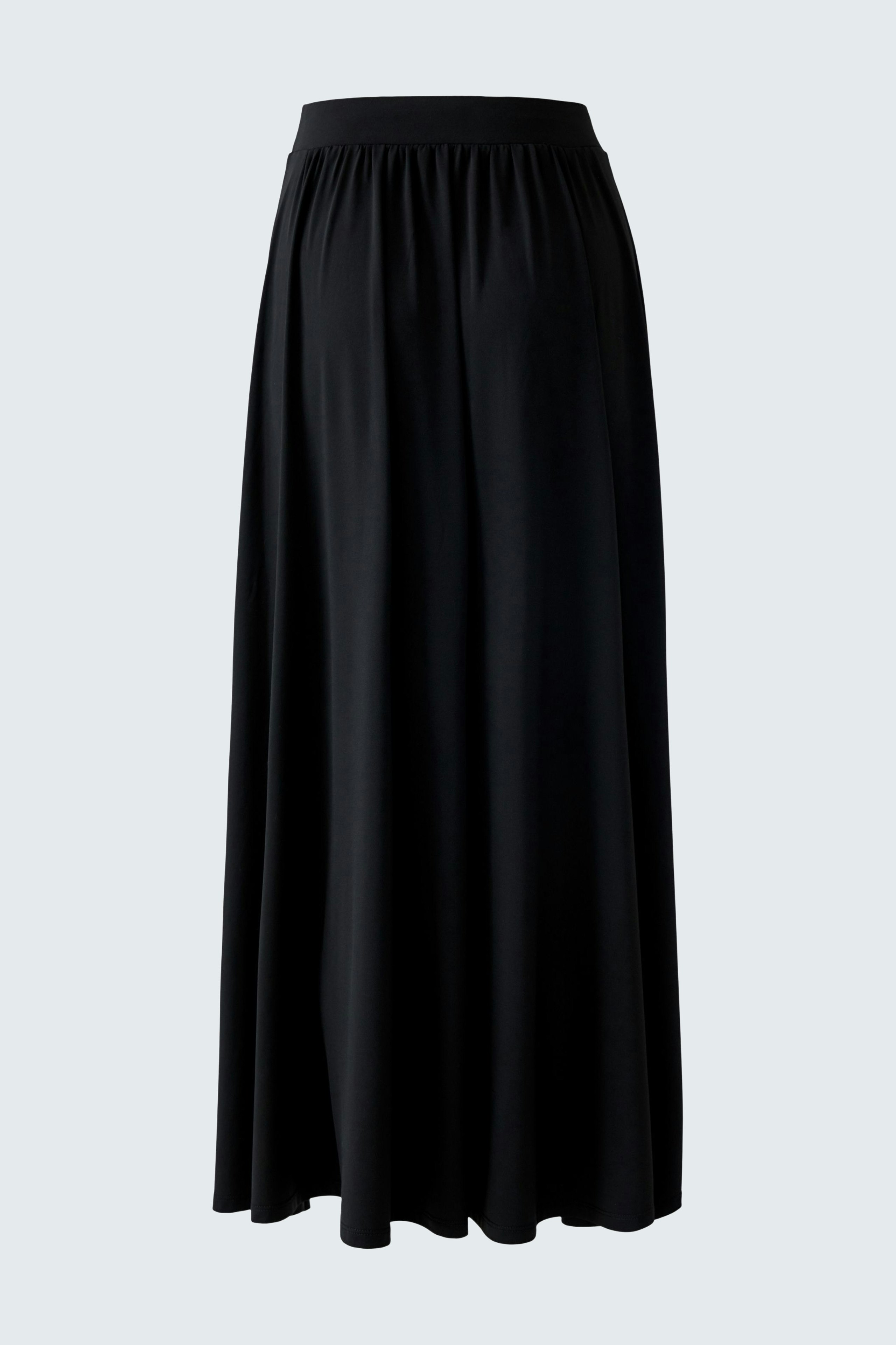 A-line skirt: A woman in a flowing black A-line skirt, perfect for casual outings.