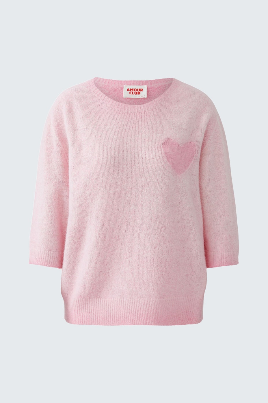 Soft pink pullover with a heart detail, perfect for casual wear.