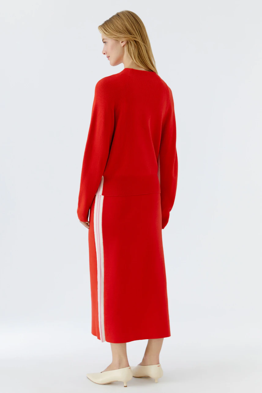 Casual women's pullover: A woman in a red pullover with a relaxed fit, showcasing a stylish back view.