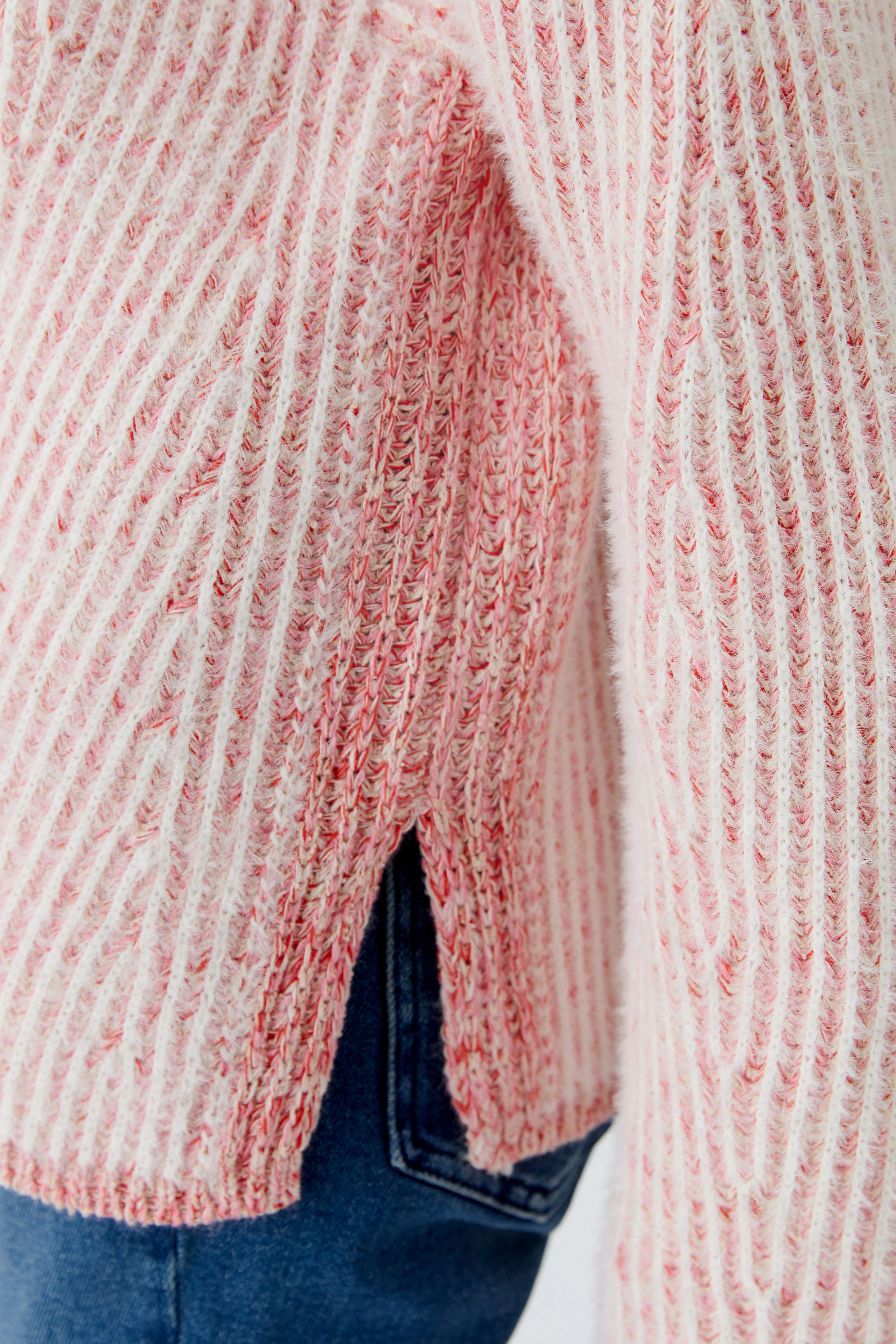 Casual women's pullover: Close-up of a pink striped pullover with side slits, perfect for everyday wear.