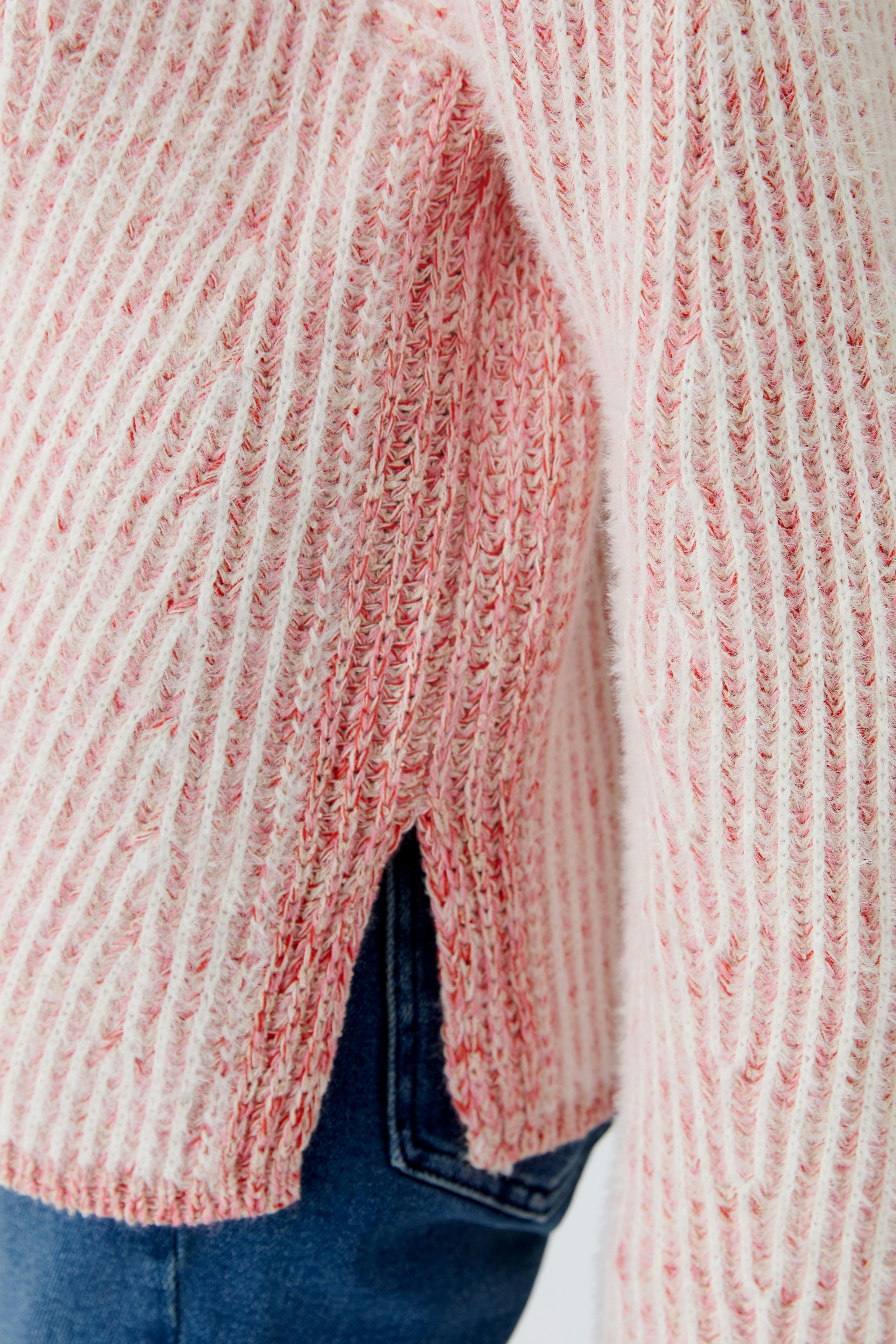 Casual women's pullover: Close-up of a pink striped pullover with side slits, perfect for everyday wear.