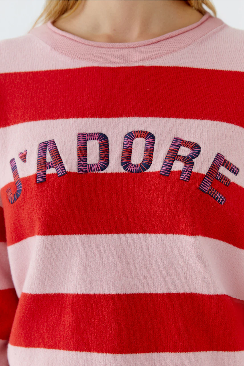Casual women's pullover: Close-up of a woman in a striped pullover with 'J'adore' embroidery.