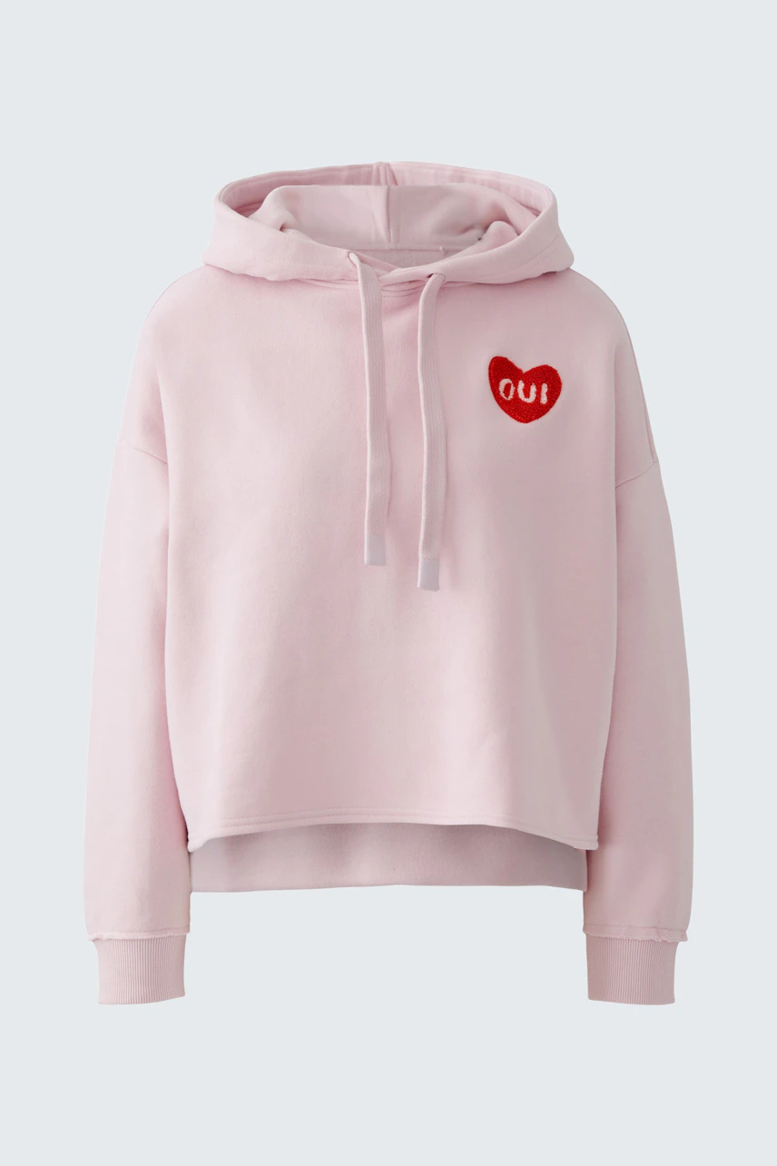 Casual women's hoodie: Light pink pullover with a red heart logo, perfect for relaxed outfits.
