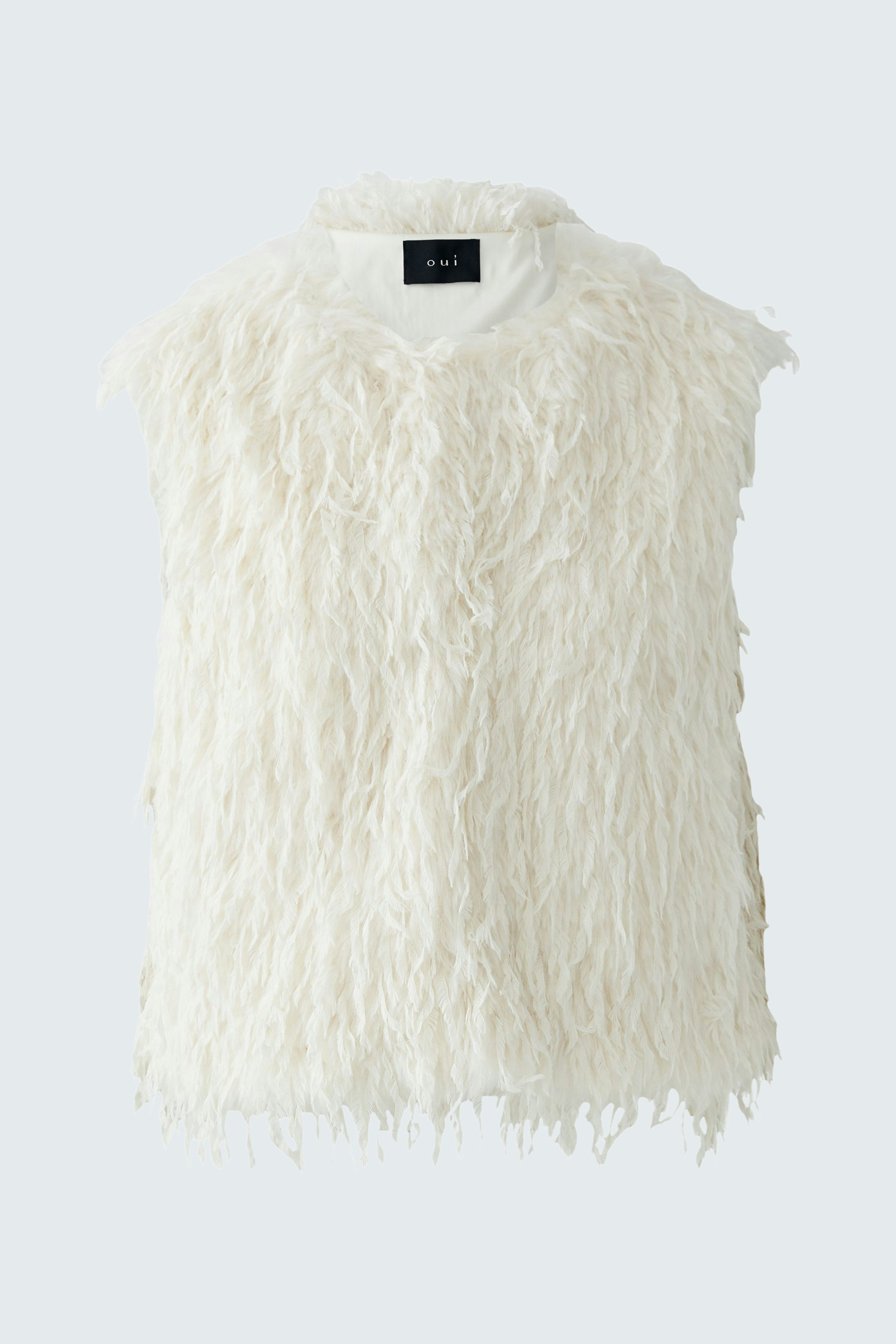 Fuzzy white vest: A stylish women's vest with a soft texture, perfect for layering.