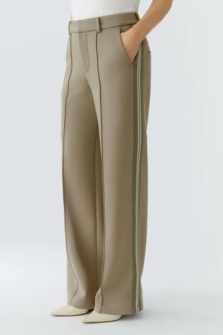 Casual women's trousers: A woman in beige wide-leg trousers with side stripes and pockets.