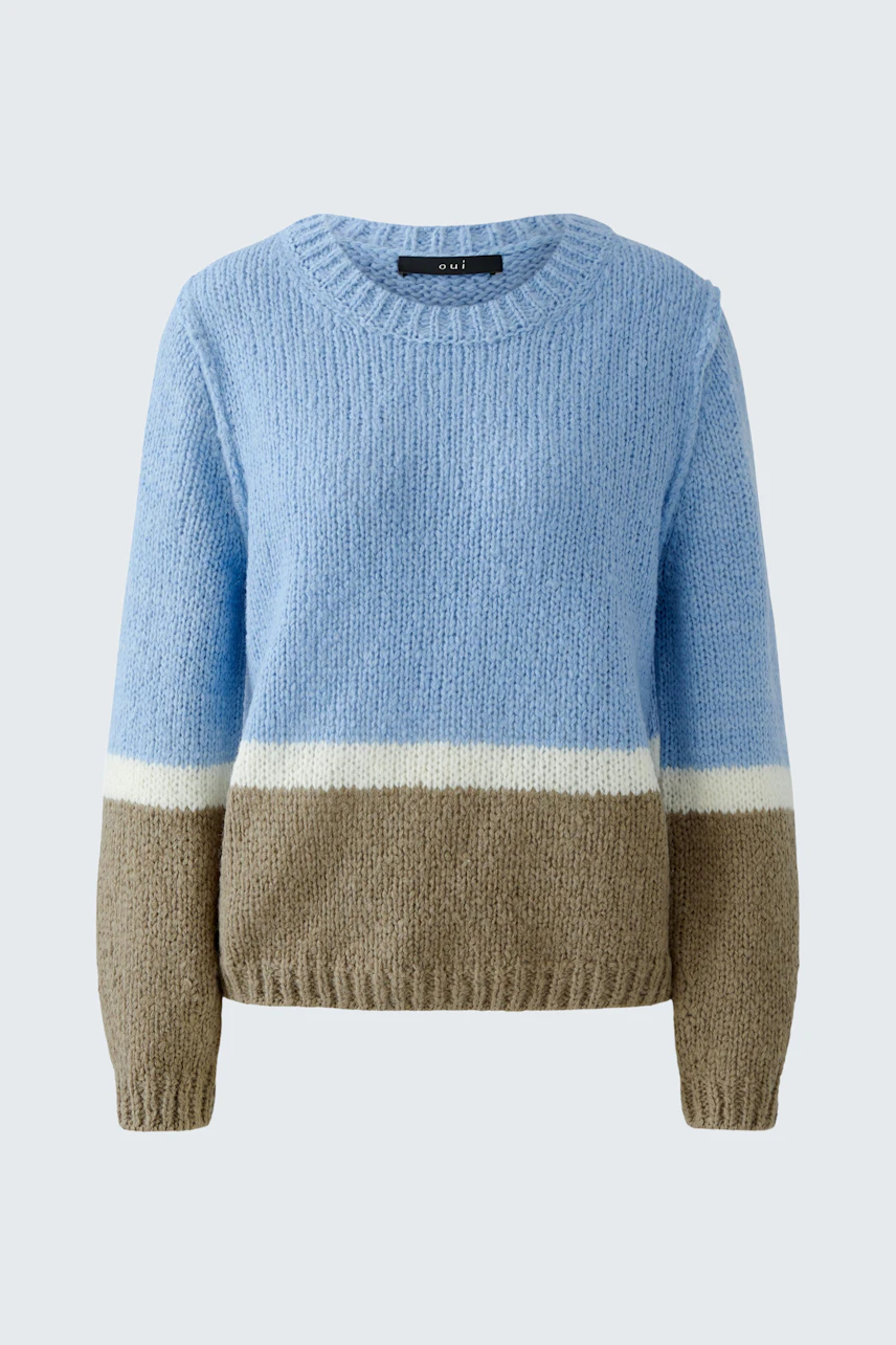Casual women's pullover: A woman in a soft blue pullover with beige and white stripes.