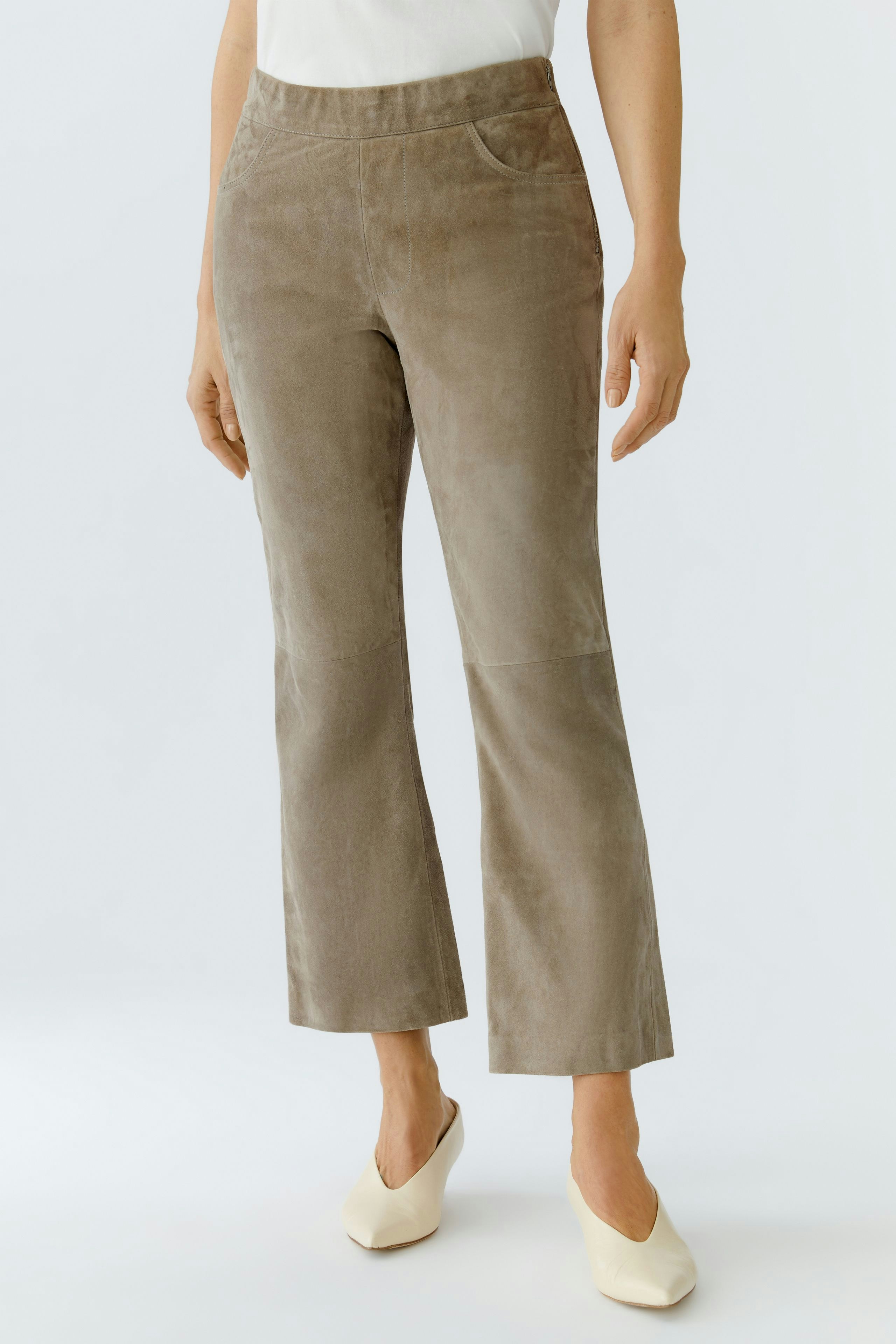 Stylish women's leather pants in a soft taupe color, featuring a flattering fit and subtle pockets.
