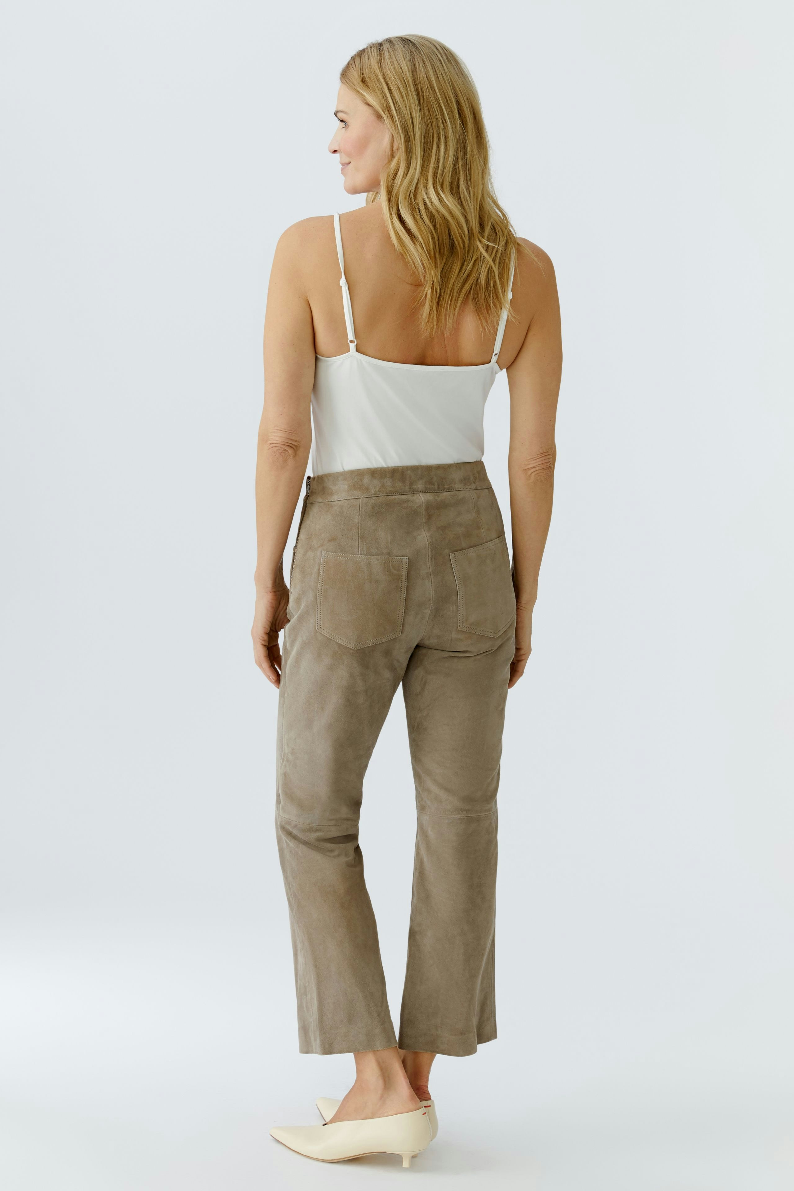 Stylish women's leather pants in soft taupe, featuring a high waist and a relaxed fit.