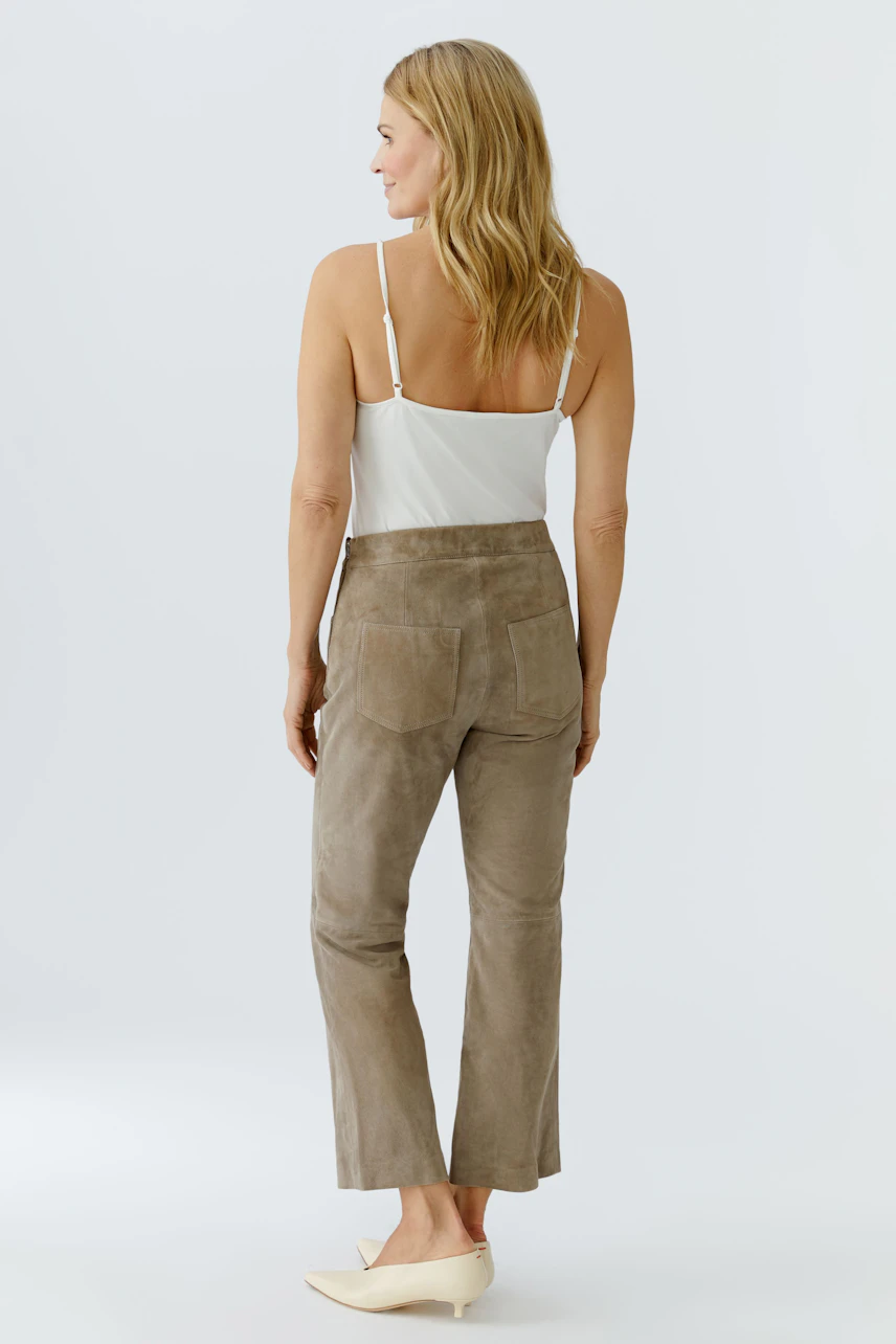 Stylish women's leather pants in soft taupe, featuring a high waist and a relaxed fit.