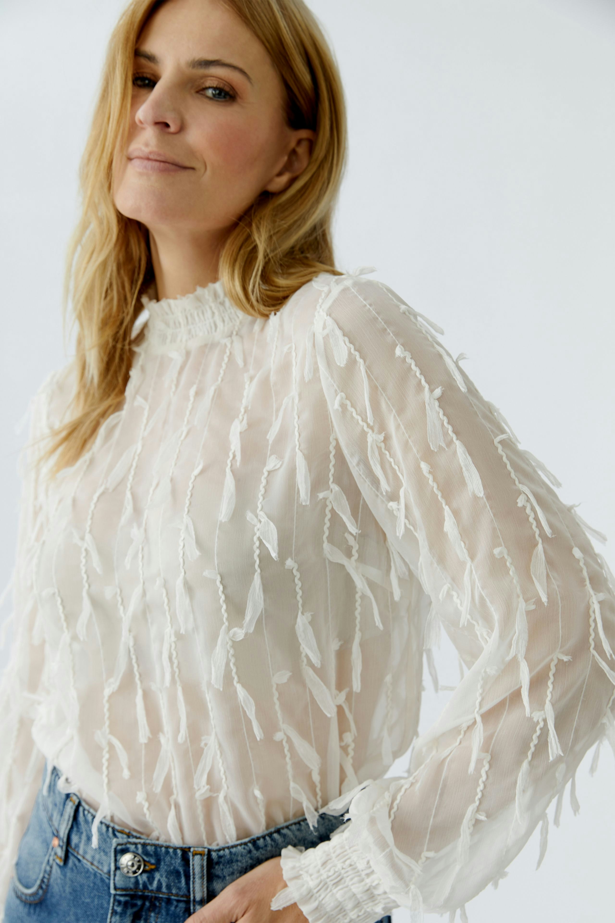 Lightweight women's blouse with textured detailing, perfect for casual wear.