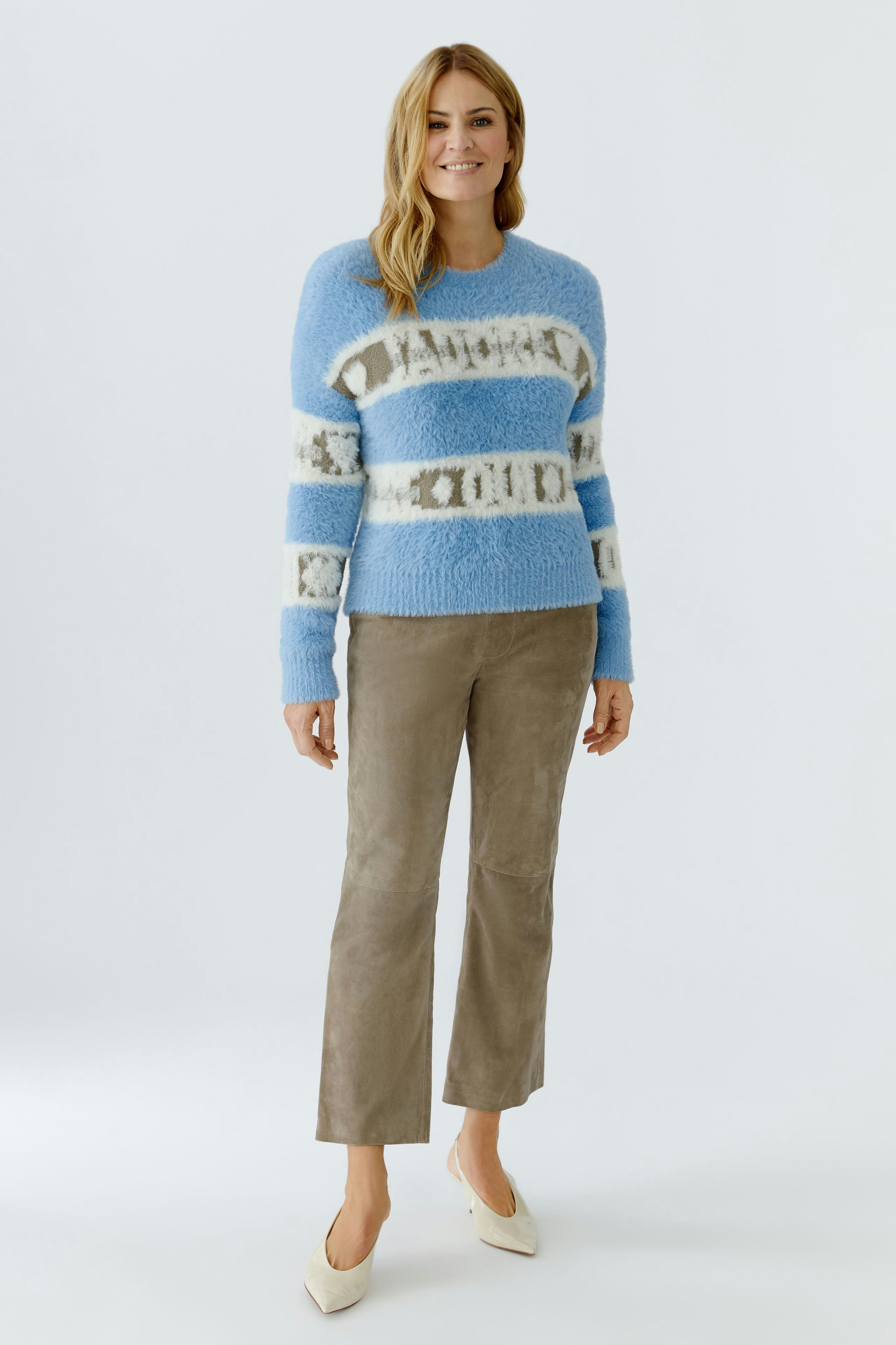 Casual women's pullover: A woman in a blue striped pullover with a relaxed fit and soft texture.