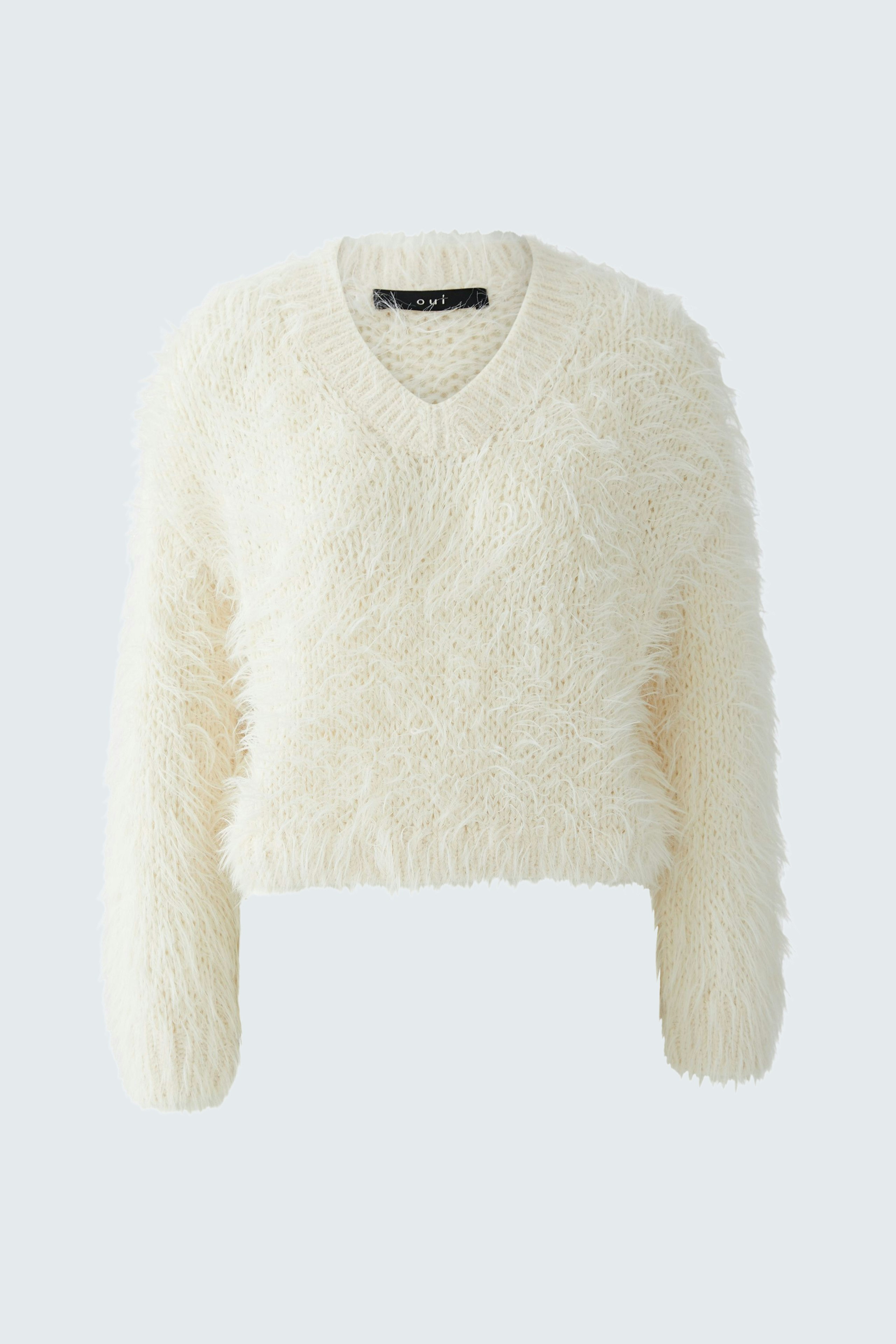 Cozy women's pullover: A fluffy white V-neck pullover with long sleeves, perfect for casual wear.