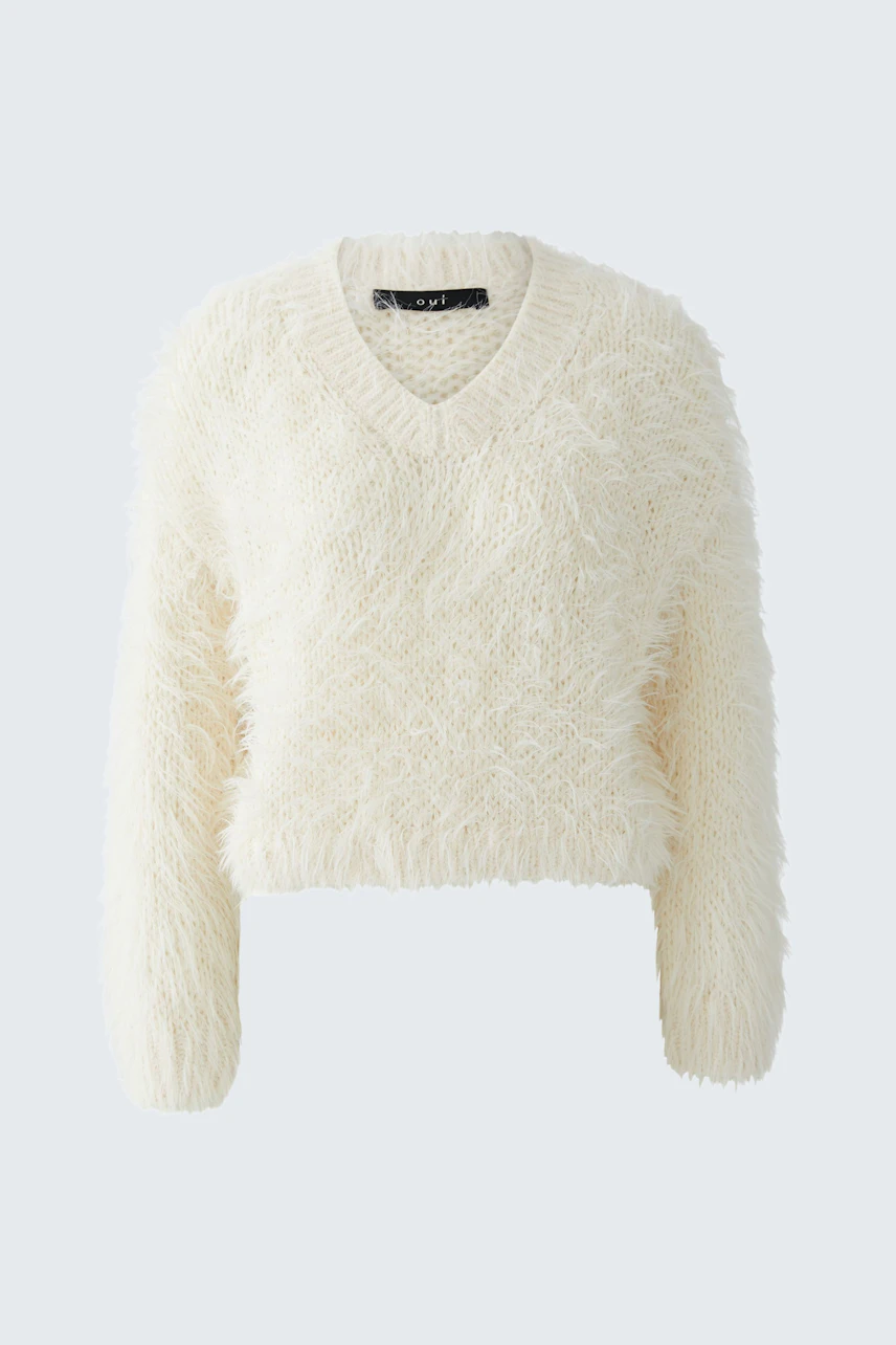 Cozy women's pullover: A fluffy white V-neck pullover with long sleeves, perfect for casual wear.