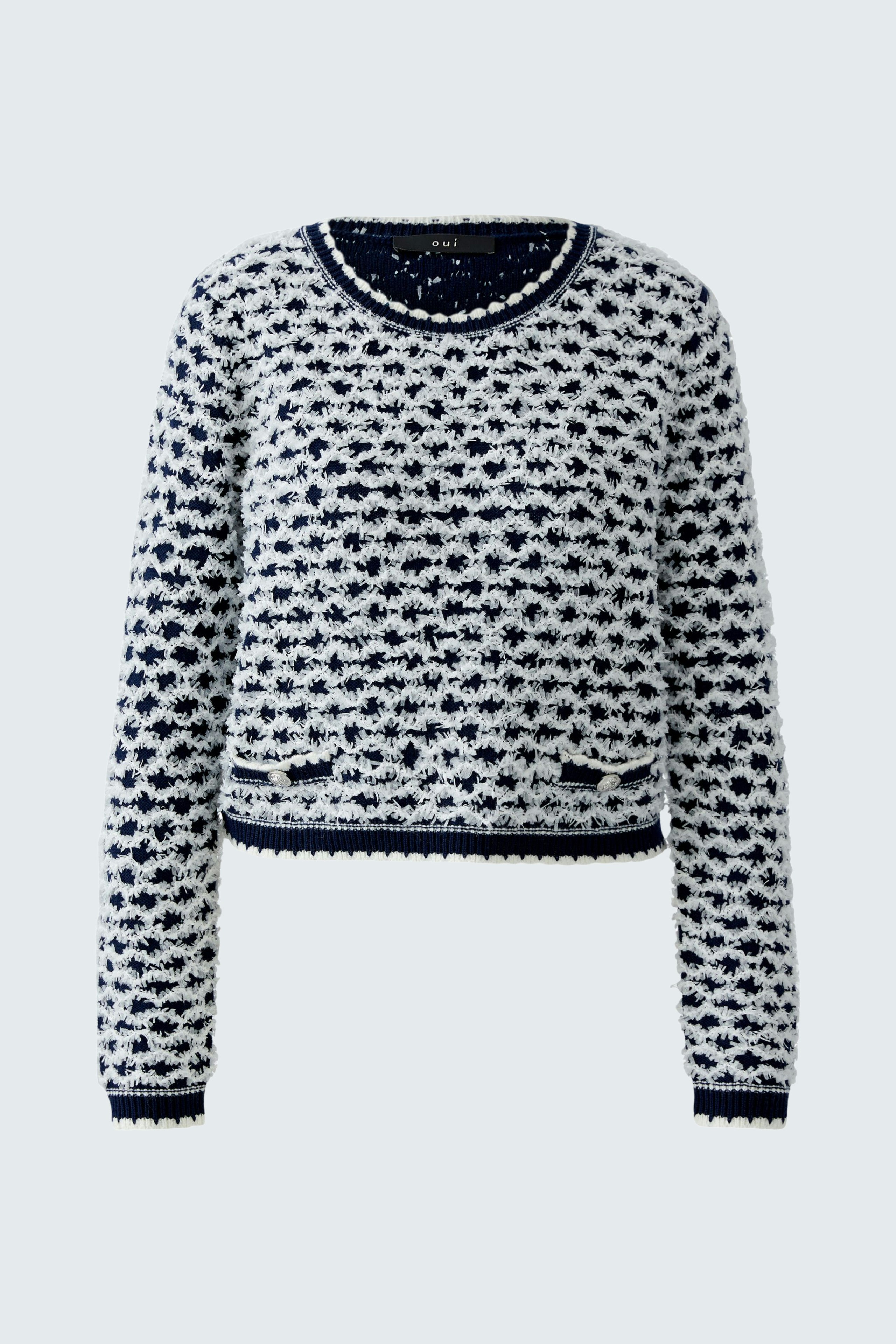Casual women's pullover: A woman in a cozy navy and white patterned pullover with a relaxed fit.
