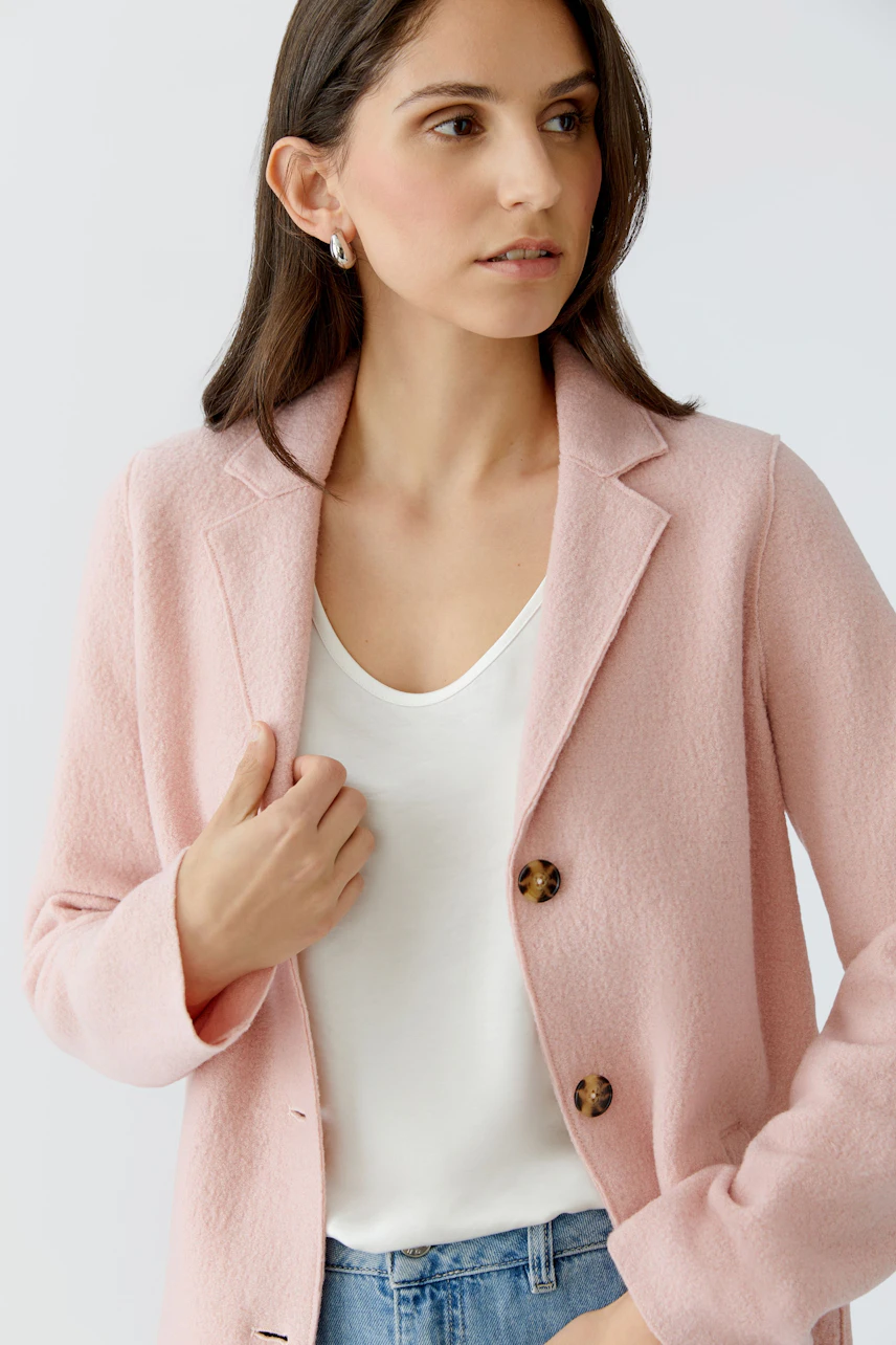 Stylish women's wool coat in soft pink, featuring a classic collar and button closure.