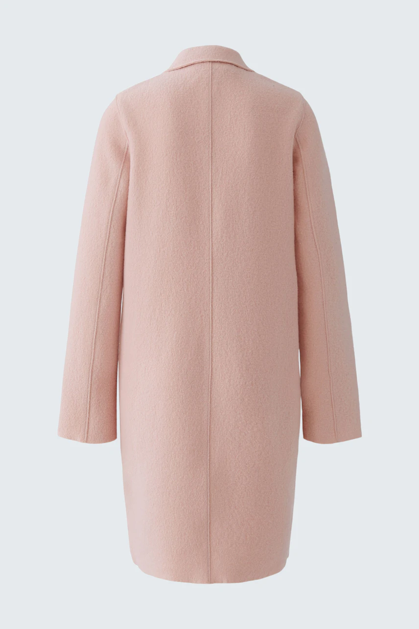 Modern women's wool coat in soft pink, featuring a relaxed fit and minimalistic design.